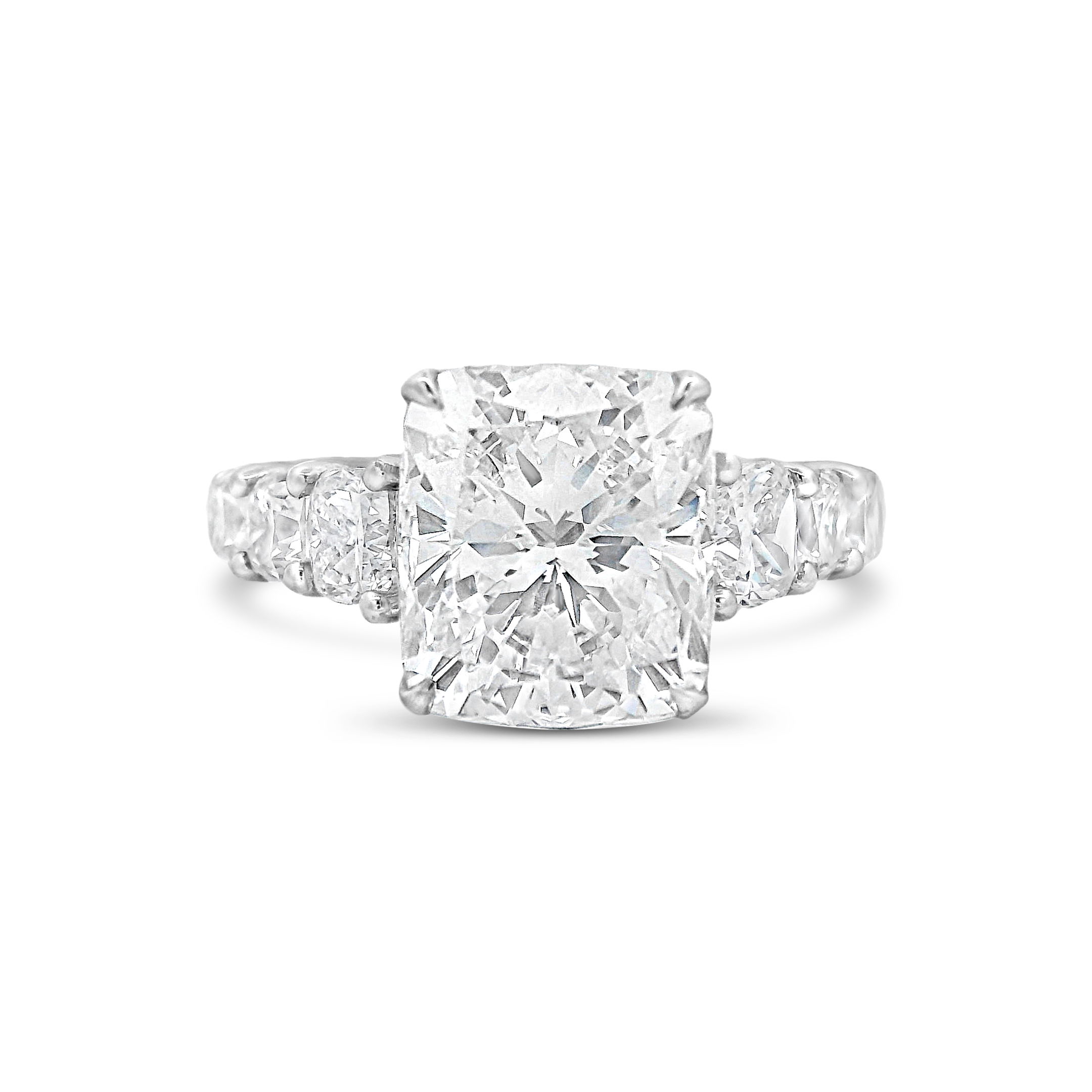This stunning 18k White gold engagement ring features six large cushion diamonds that highlight the center stone’s beauty, creating a timeless and luxurious look. Perfect for those seeking a statement piece that exudes elegance and sophistication. (Center diamond sold separately)-18k White gold-Cushion diamond, 5.05ct (sold separately)-Cushion diamonds, 2.29cts-Size 6.5, Contact for sizing optionsItem# 100-00817 Cushion 5.05ct Engagement Ring Mount