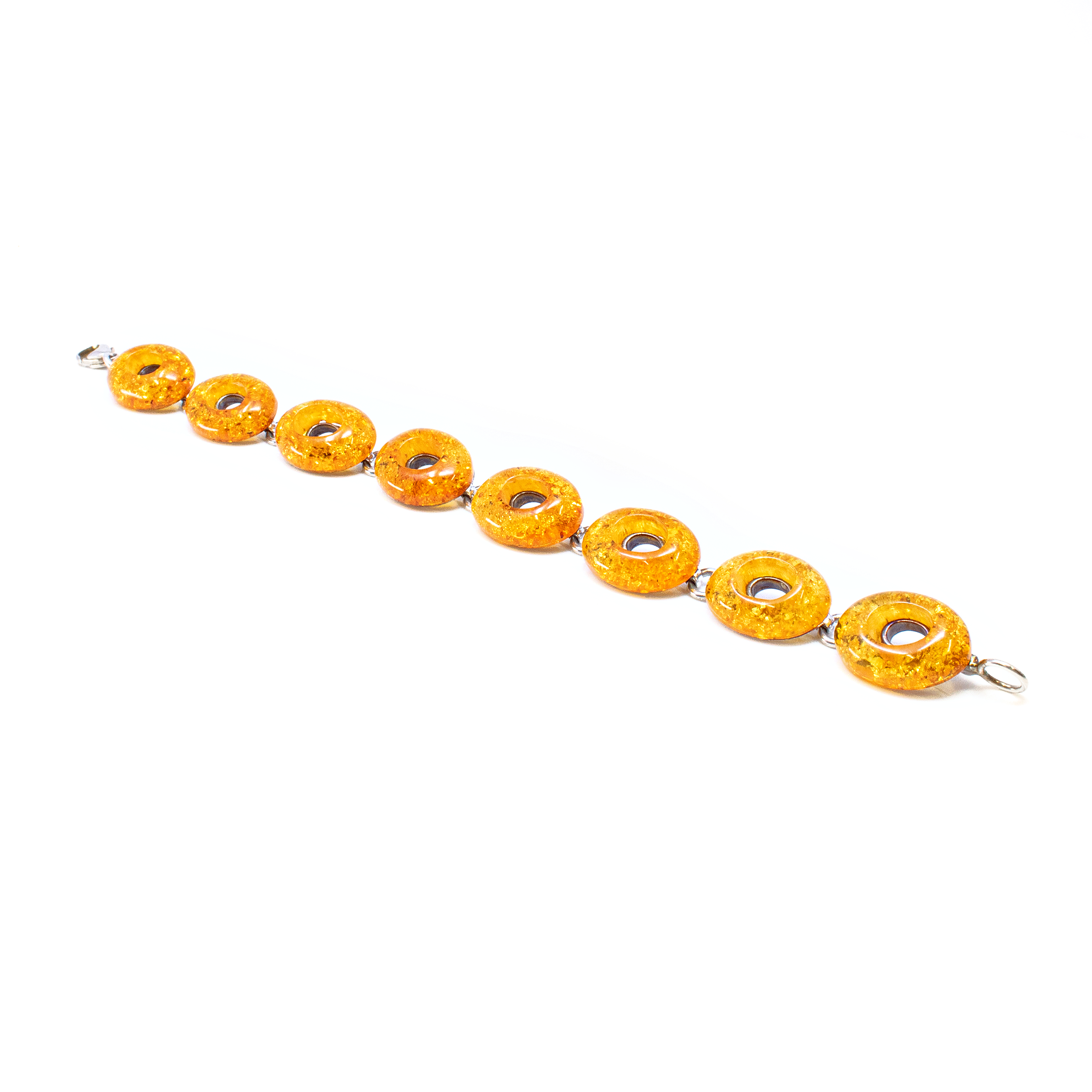 Introducing the Cognac Amber Link Bracelet, a masterpiece of elegance and sophistication that is sure to captivate. This exquisite bracelet features stunning oval-shaped amber stones, each with a unique cognac hue that radiates warmth and charm. Notably, the amber ovals are designed with intricate cutout middles, allowing light to pass through and creating a mesmerizing play of colors.Crafted with precision, the bracelet's framework is composed of high-quality 925 sterling silver, providing a durable and luxurious setting that perfectly complements the rich amber tones. The polished silver links connect each oval seamlessly, offering flexibility and comfort with every wear. Cognac Amber Link Bracelet -Ovals With Cutout Middles