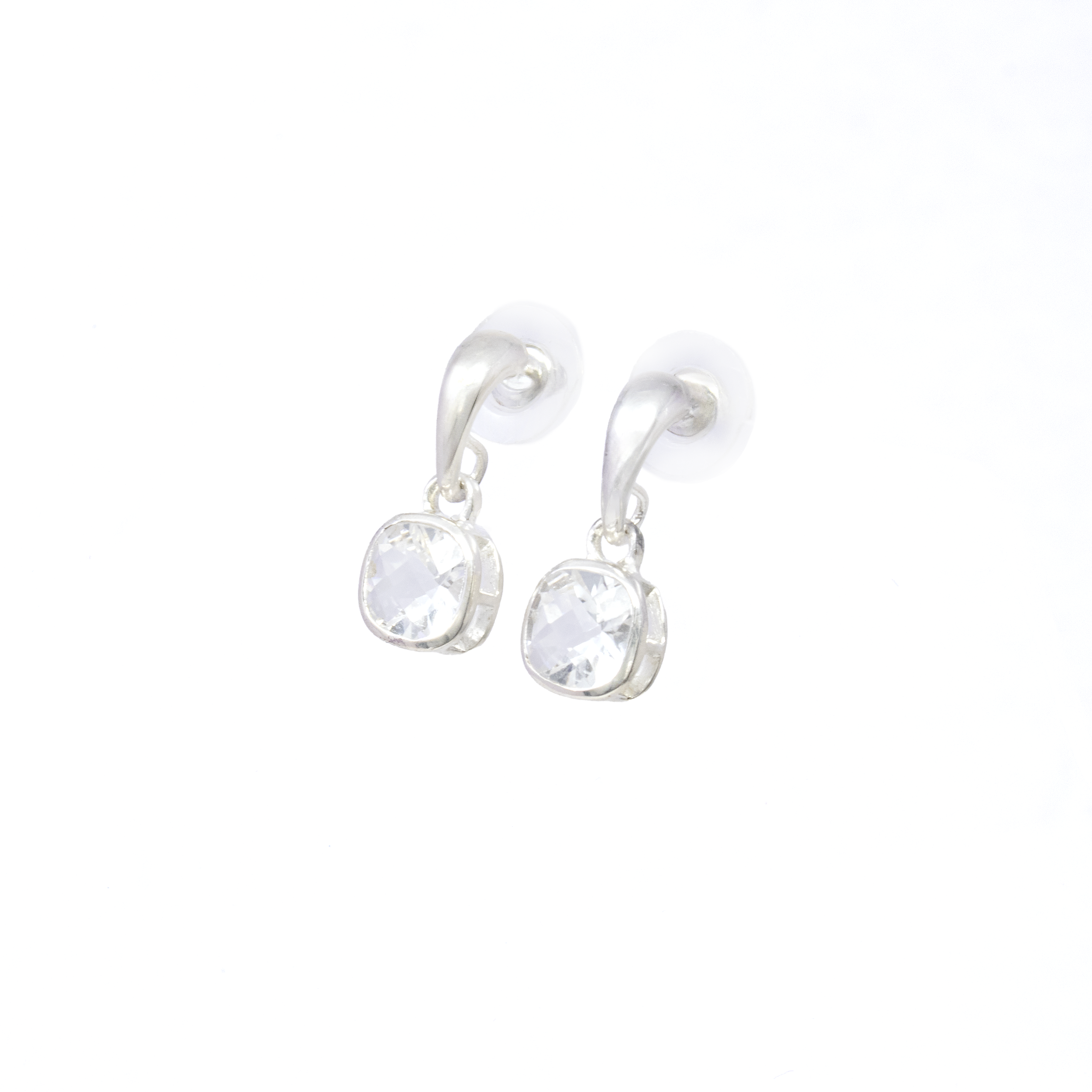 Add a touch of elegance to your jewelry collection with our exquisite Quartz Dangle Earrings. These beautifully designed earrings feature faceted rectangular quartz gemstones, known for their pristine clarity and understated sophistication. Encased in a uniquely crafted cutout bezel setting, each quartz stone captures light effortlessly, creating a dazzling play of brilliance with every movement.Crafted from premium 925 sterling silver, the earrings boast a tapered bail that adds a modern twist, enhancing the overall aesthetic. The fine detailing in the sterling silver complements the sparkling quartz, making these earrings a versatile accessory for both day and night. Quartz Dangle Earrings - Faceted Rectangle With Cutout Bezel & Tapered Bail