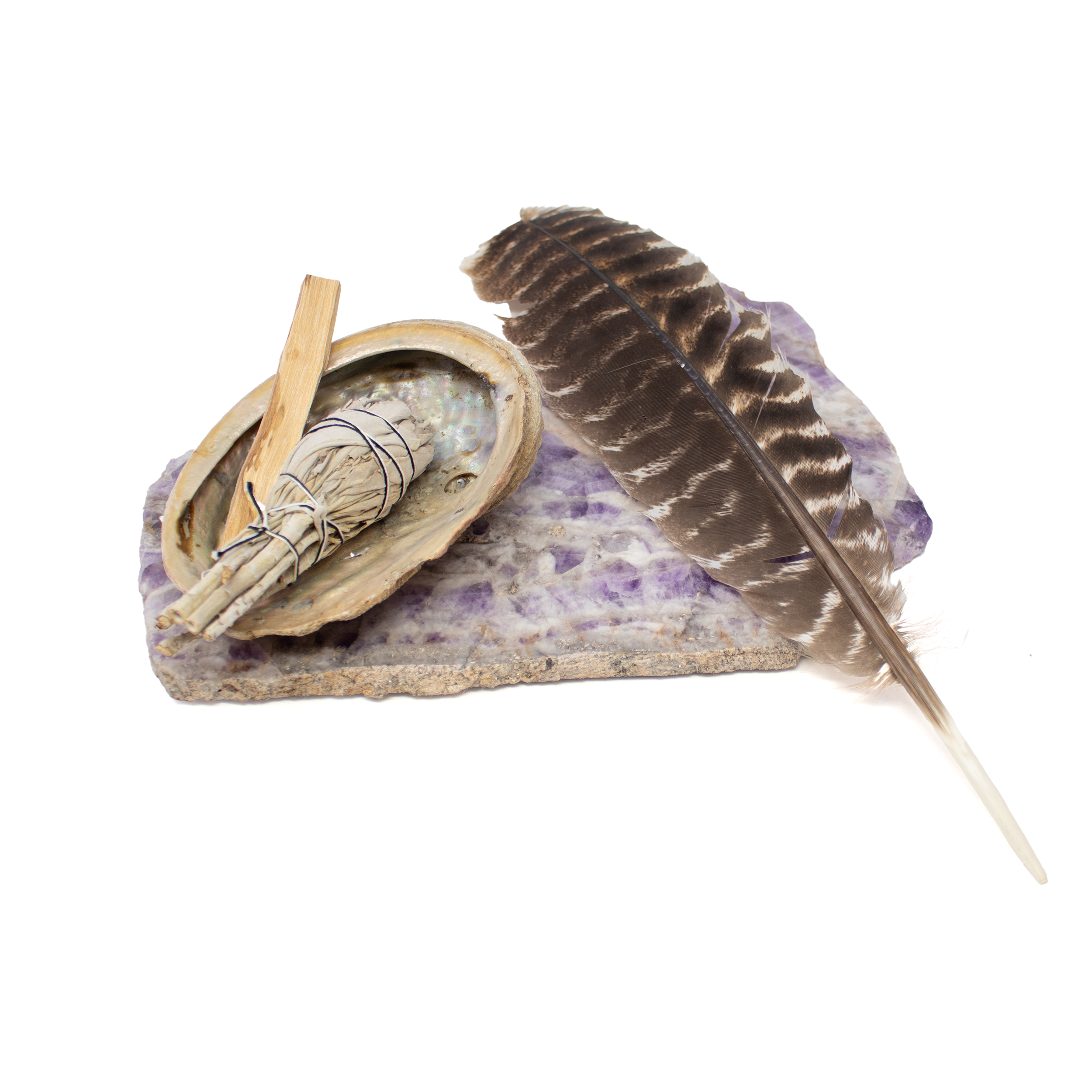 Relax and focus your energies with our Aromatherapy Kit. Includes Chevron Amethyst Platter, Abalone Shell, Palo Santo sticks, and a White Sage Tulip. Amplify healing energy with the Amethyst Platter. Abalone Shell helps purify energy during meditation. Palo Santo sticks and Sage cleanse negative energy. For beginners or professionals seeking balance and calm in their lives. Aromatherapy Kit: Chevron Amethyst Platter with Abalone Shell & Palo Santo & White Sage Tulip & Feather
