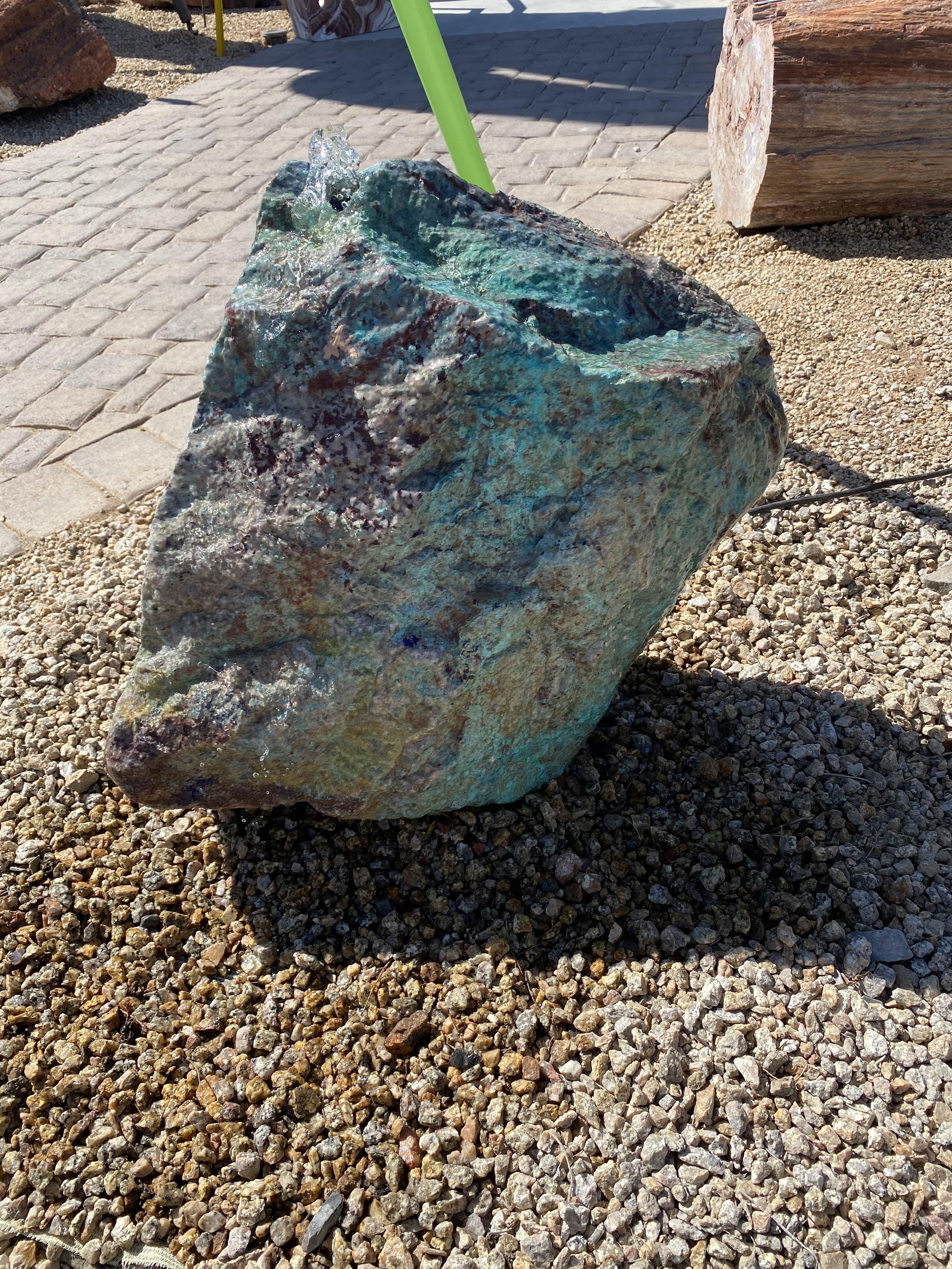 The Morenci Chrysocolla Copper Ore Boulder Fountain adds a serene and beautiful touch to any outdoor space. Its soothing water flow promotes tranquility while its unique design enhances the aesthetic appeal of your yard, garden, or patio. Let Rare Earth Gallery’s white-glove service make your fountain dreams come true—simply choose your fountain, tell us where it goes, and we’ll handle the rest, from delivery to installation. IMPORTANT: the purchase price listed is for the FOUNTAIN ONLY and DOES NOT INCLUDE the cost of a basin, pump, parts or installation. Before purchasing a fountain online, we STRONGLY recommend you call us at (480) 575-4360 for a FREE consultation to discuss these additional costs and schedule a pre-site inspection. Also, free shipping does NOT apply to fountains, please call for a quote. Morenci Chrysocolla Copper Ore Boulder Fountain