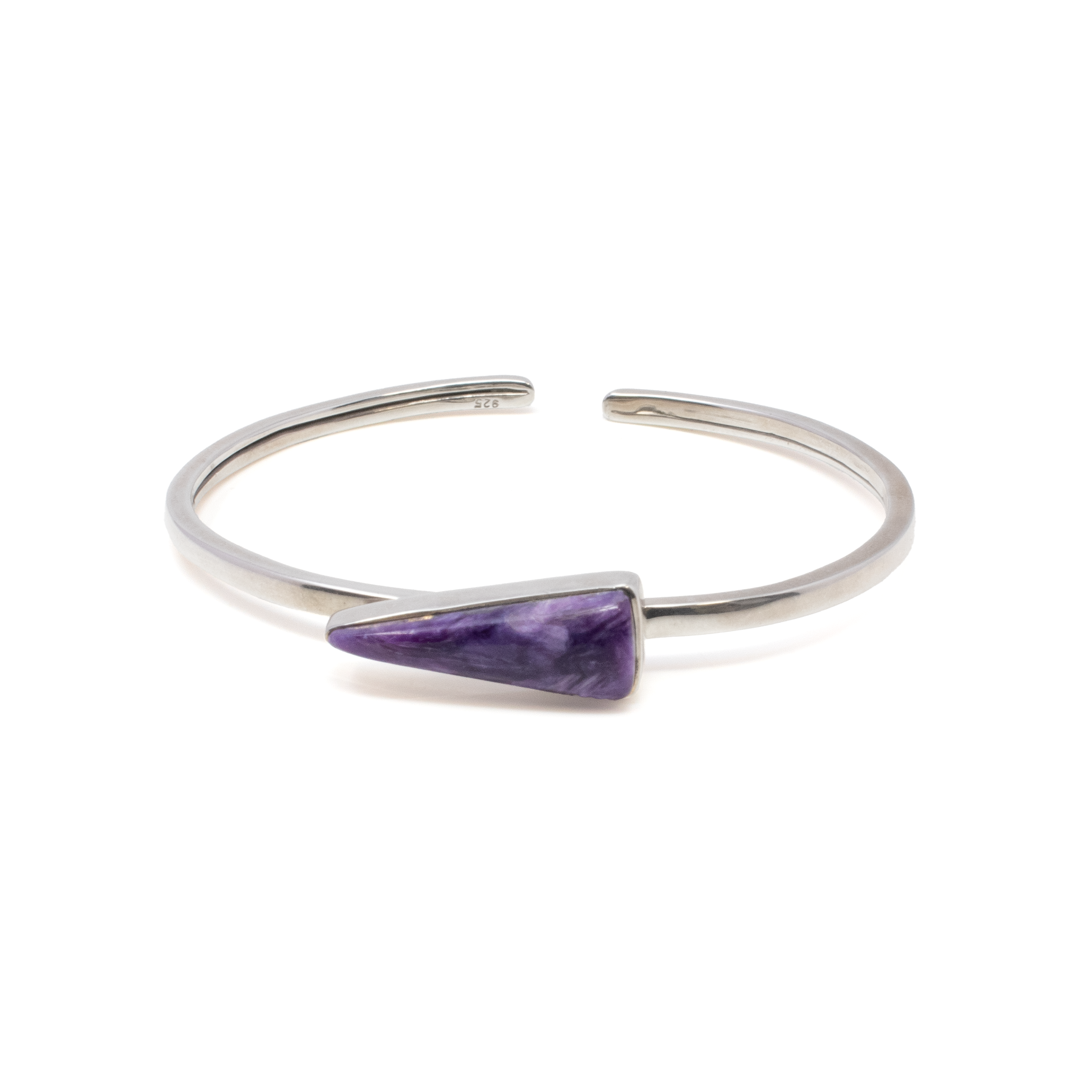 Elevate your jewelry collection with the stunning Charoite Twist Bracelet, a masterpiece that effortlessly blends elegance and nature's artistry. This exquisite bracelet showcases a mesmerizing pennant cabochon of charoite, a rare and captivating gemstone known for its swirling lavender and violet hues, reminiscent of a mystical dance of colors.Encased in a meticulously crafted 925 sterling silver bezel, the charoite cabochon takes center stage, offering a harmonious balance of sophistication and natural allure. The bracelet's unique twist design adds a contemporary touch, making it a versatile piece suitable for both everyday elegance and special occasions. Charoite Twist Bracelet - Pennant Cabochon With Silver Bezel