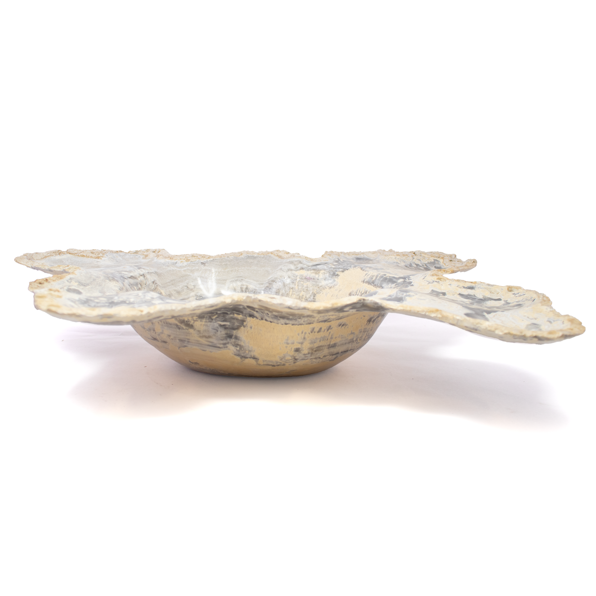 Hewn from ancient stone and polished to a mirror-like sheen, the High Polished Gray Gold Onyx Bowl is a study in contrast—earthbound yet luminous, rugged yet refined. Bands of smoky gray and warm gold ripple across its surface like liquid strata, each pattern unrepeatable, each curve shaped by time and the artisan’s hand. Sourced from premium Mexican onyx and finished to a high gloss, it glows from within, catching light in quiet, golden flashes.Whether gracing a dining table, resting atop a console, or standing alone in a place of honor, this vessel transforms any space with its elemental elegance. At once functional and sculptural, it holds space as much as it holds objects—perfect for curating treasured items or simply being admired in its own right. High Polished Gray Gold Onyx Bowl