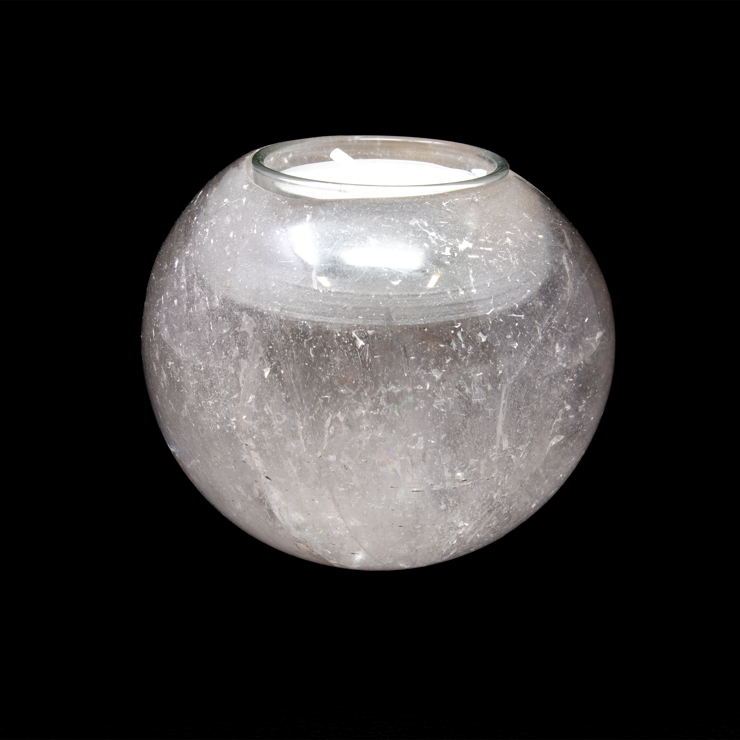 Elevate the ambiance of your home with our exquisite Clear Quartz Sphere Candle Holder. This luxurious piece is more than just a candle holder; it's a work of art and a symbol of elegance and tranquility. Crafted from high-quality, fully polished clear quartz, this candle holder embodies the perfect blend of natural beauty and sophisticated design.The sphere shape of the holder highlights the natural clarity and luminosity of the quartz, creating a captivating visual effect that complements any home decor style.Made from premium-grade clear quartz, this candle holder is not only beautiful but also durable, ensuring lasting quality and shine. Clear Quartz Sphere Candle Holder
