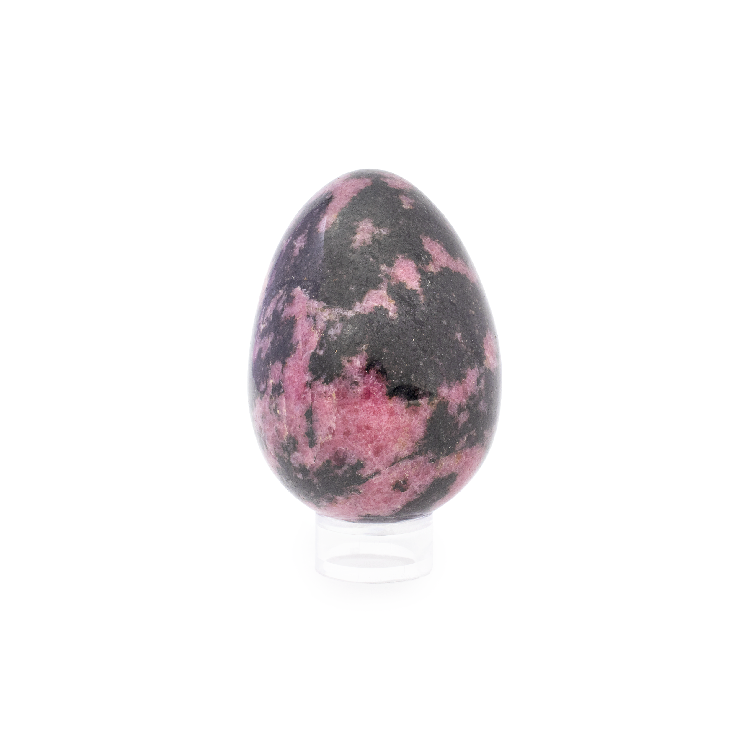 Add a touch of elegance and natural beauty to your collection with our stunning Rhodonite Egg. This exquisite piece showcases the charming hues and unique characteristics that make rhodonite a sought-after mineral. Its light pink surface is artistically splashed with subtle yet striking hot pink undertones, creating a harmonious display of color that captivates the eye.Each Rhodonite Egg is carefully polished to highlight its inherent patterns and vibrant shades, making it a perfect addition to any mineral collection or home decor display. Known for their soothing and balancing energy, rhodonite stones are often associated with compassion, emotional healing, and self-love, making this elegant egg not only a visual delight but also a source of positive energy. Rhodonite Egg - Light Pink Splashing With Hot Pink Undertones
