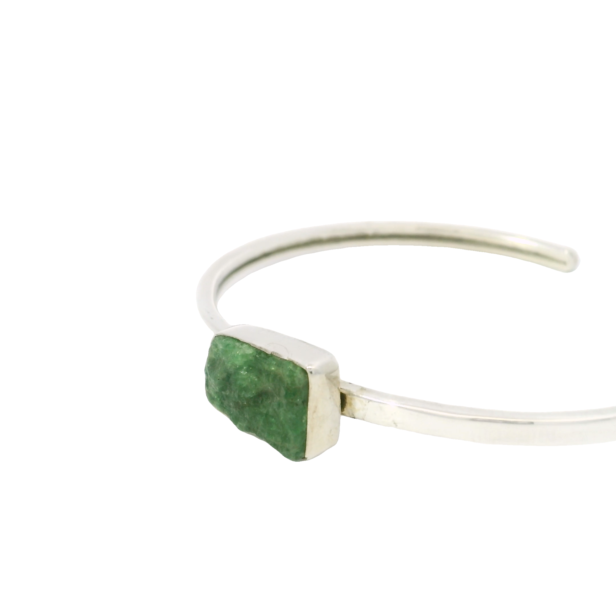 Introducing the Emerald Twist Bracelet – a stunning piece that effortlessly combines elegance and natural beauty. This exquisite bracelet features a captivating array of rough freeform emeralds, each encased in a sleek silver bezel setting that highlights their unique shapes and vibrant green hues. Crafted with precision and care, the bracelet's design celebrates the raw beauty of these precious gemstones, making it a truly one-of-a-kind accessory.The bracelet is artfully connected with links of 925 sterling silver, ensuring durability and a sophisticated shine. This choice of high-quality materials not only adds to the bracelet's timeless elegance but also offers a comfortable fit for any wrist. The Emerald Twist Bracelet is perfect for those who appreciate understated luxury and the allure of natural gemstones. Emerald Twist Bracelet - Simple Rough Freeform With Silver Bezel
