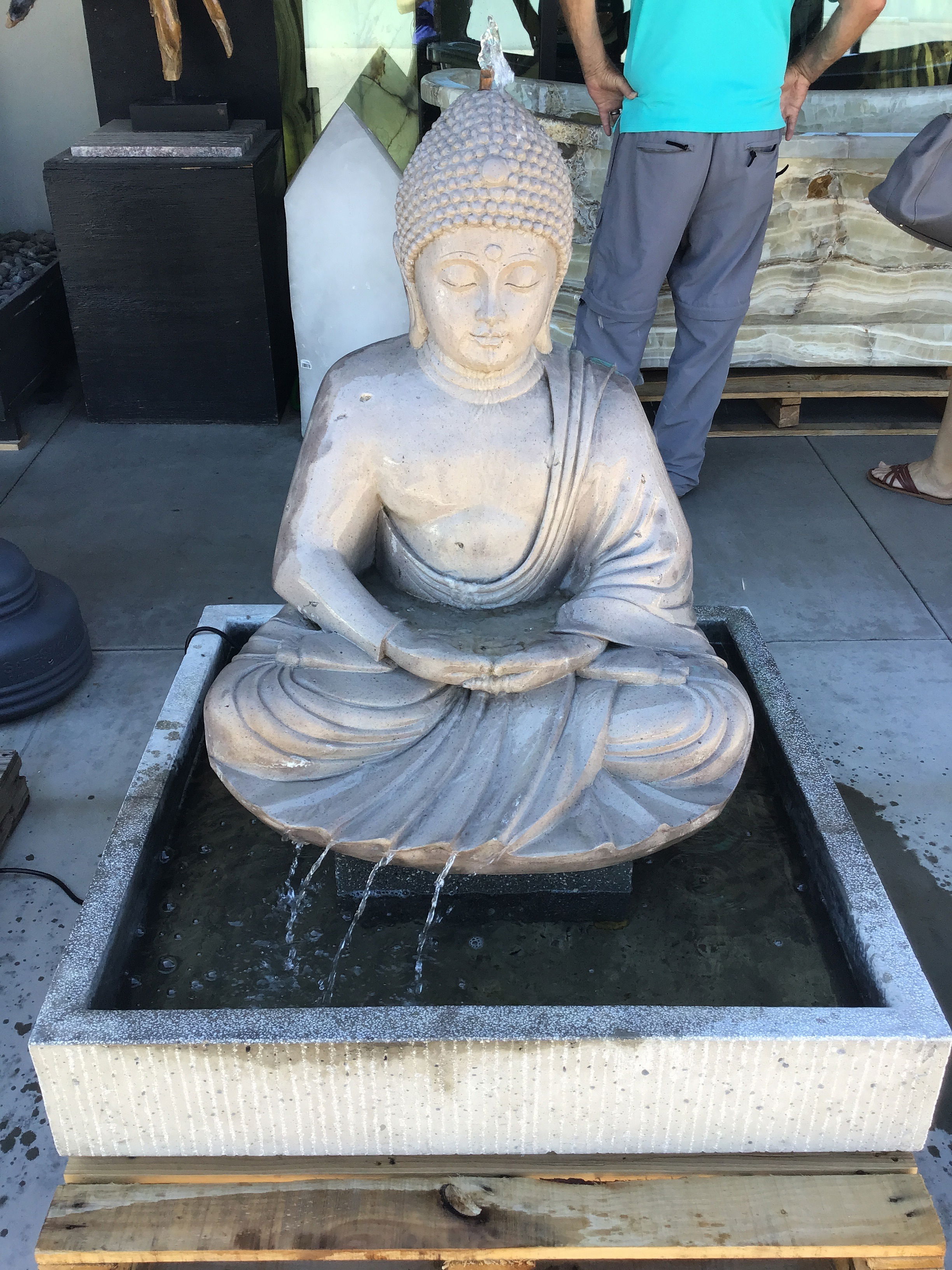 The Buddha Cantera Fountain with Concrete Base and Rock brings serenity and beauty to your yard, garden, or patio. Its soothing flowing water creates a peaceful ambiance, promoting tranquility and enhancing the overall aesthetic appeal of your outdoor space. Let Rare Earth Gallery’s white-glove service make your fountain dreams come true—simply choose your fountain, tell us where it goes, and we’ll handle the rest, from delivery to installation. IMPORTANT: the purchase price listed is for the FOUNTAIN ONLY and DOES NOT INCLUDE the cost of a basin, pump, parts or installation. Before purchasing a fountain online, we STRONGLY recommend you call us at (480) 575-4360 for a FREE consultation to discuss these additional costs and schedule a pre-site inspection. Also, free shipping does NOT apply to fountains, please call for a quote. Buddha Cantera Fountain with Concrete Base & Rock