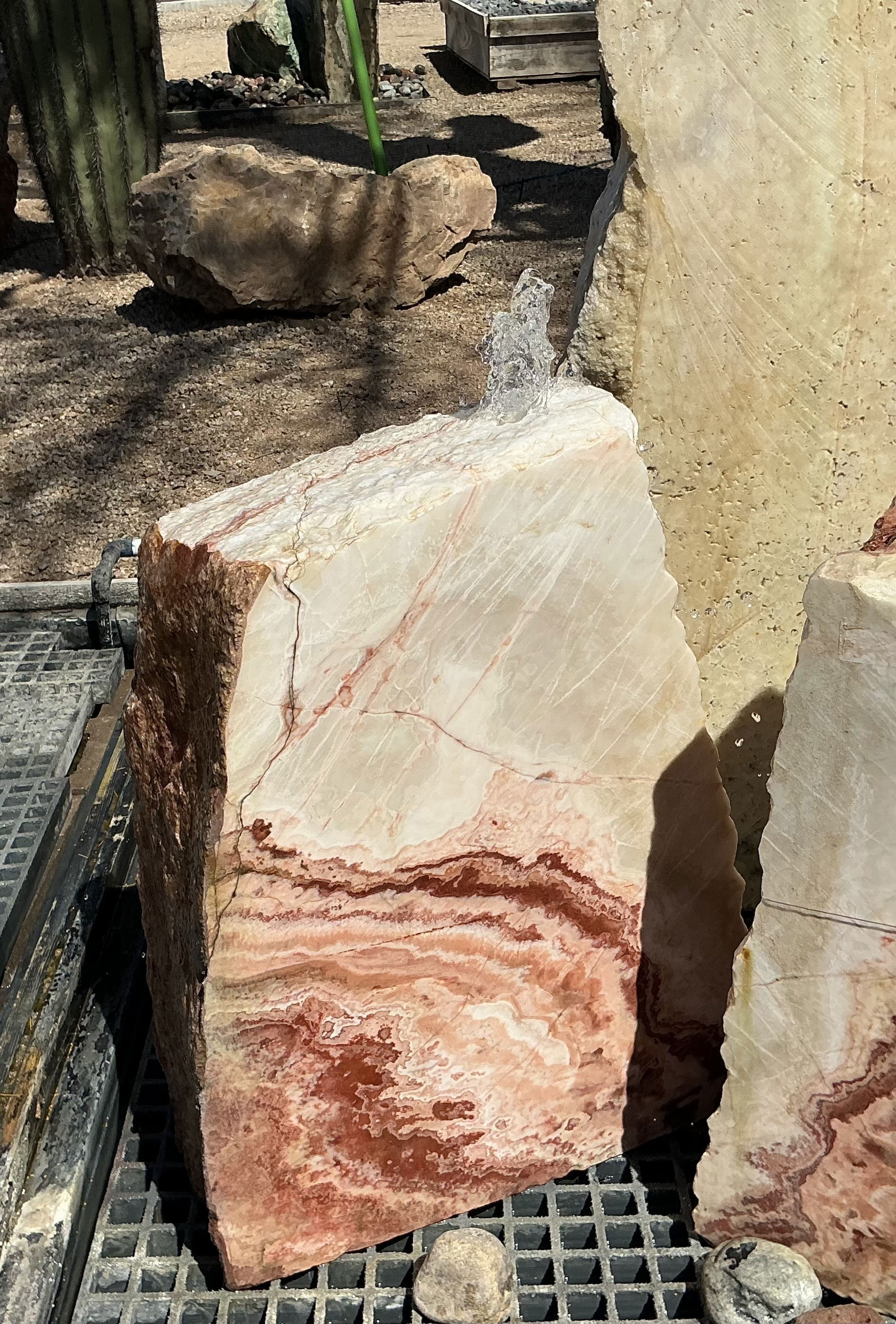 The Rosa Cherry Blossom Onyx Fountain enhances any outdoor space with its tranquil ambiance and visually stunning design. Immerse yourself in serenity as the soothing sound of water creates a peaceful atmosphere, making it the perfect addition to your yard, garden, or patio. Let Rare Earth Gallery’s white-glove service make your fountain dreams come true—simply choose your fountain, tell us where it goes, and we’ll handle the rest, from delivery to installation. IMPORTANT: the purchase price listed is for the FOUNTAIN ONLY and DOES NOT INCLUDE the cost of a basin, pump, parts or installation. Before purchasing a fountain online, we STRONGLY recommend you call us at (480) 575-4360 for a FREE consultation to discuss these additional costs and schedule a pre-site inspection. Also, free shipping does NOT apply to fountains, please call for a quote. Rosa Cherry Blossom Onyx Fountain - 1 Side Cut
