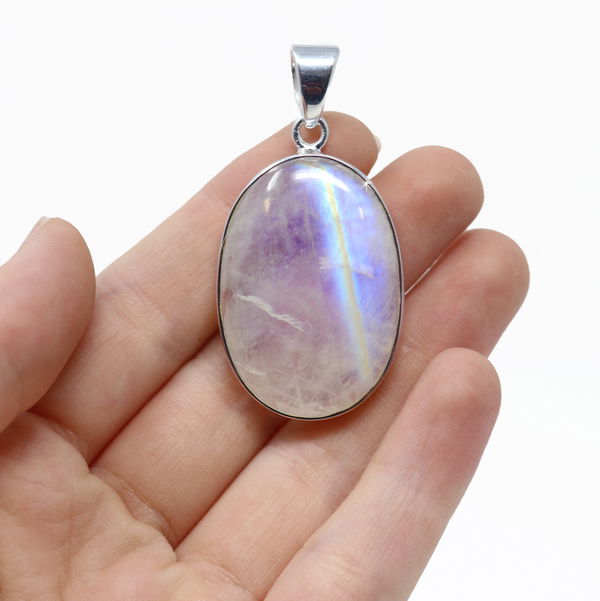 Closeup photo of Rainbow Moonstone Pendant - Oval Cabochon with Silver Bezel - Hidden Brilliant Rainbow Flash