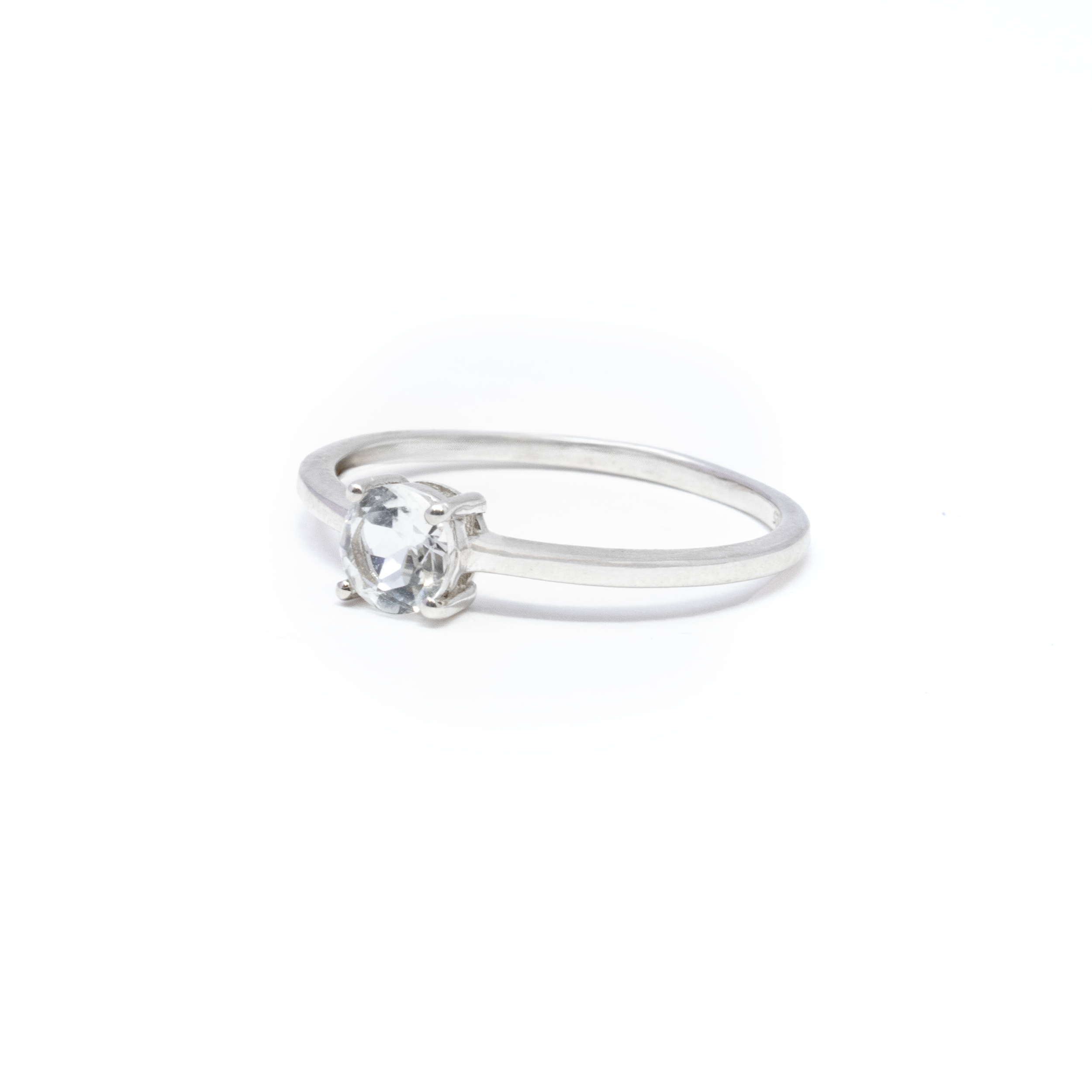 Elevate your elegance with our exquisite White Topaz Ring, intricately designed to add a touch of sophistication to any ensemble. This dainty yet dazzling ring features a beautifully faceted round white topaz gemstone, renowned for its brilliant clarity and understated charm. The centerpiece, a pristine white topaz, is expertly prong-set to enhance its natural sparkle, ensuring it catches the light with every movement. The minimalist design, focused on the gemstone's captivating allure, makes it a timeless piece that can be worn for any occasion, from casual outings to formal gatherings. White Topaz Ring - Dainty Faceted Round - Prong Set Sz8