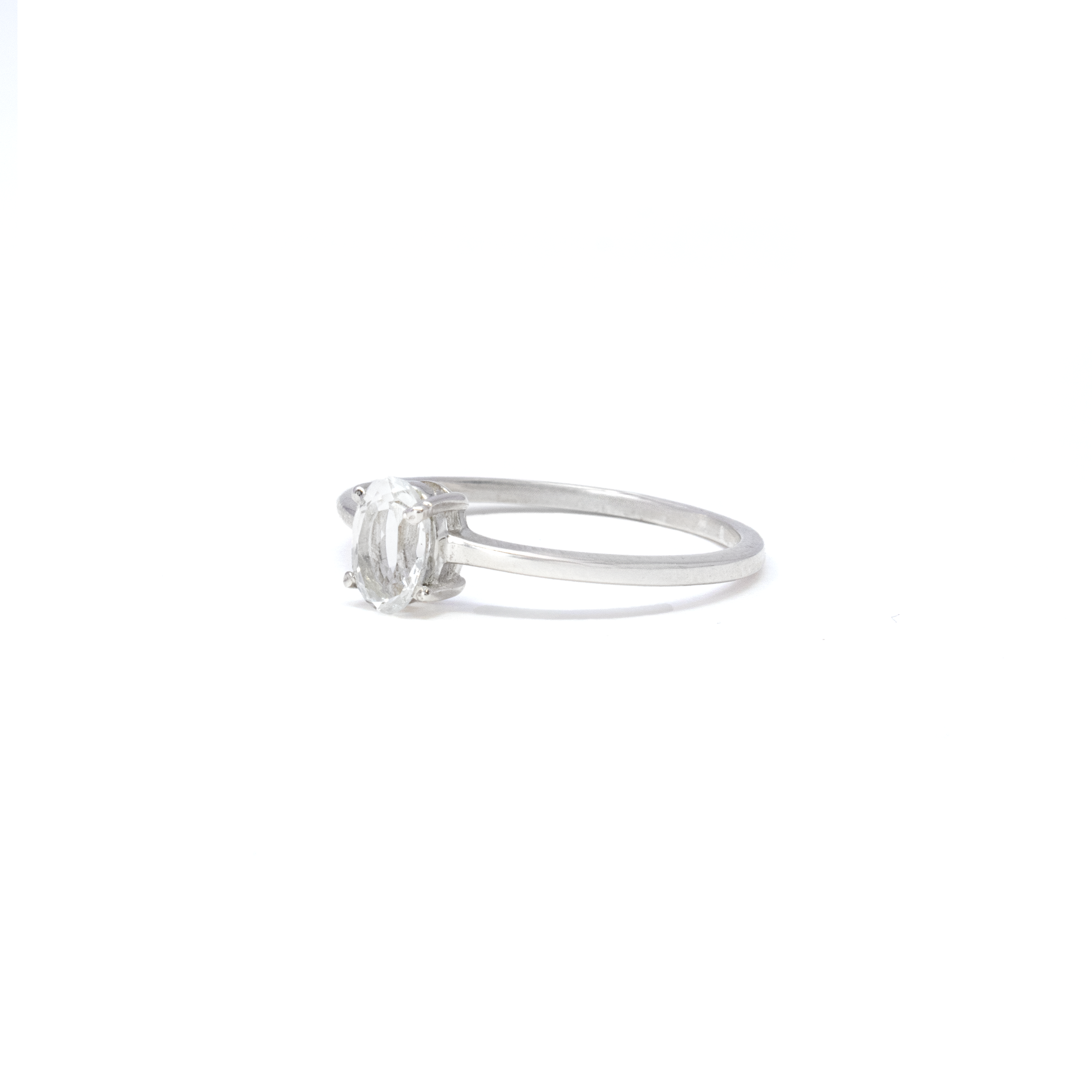 Enhance your jewelry collection with the elegance of the Dainty Faceted Oval White Topaz Ring. This stunning piece features a pristine, faceted oval white topaz gemstone known for its captivating sparkle and timeless beauty. Expertly prong-set to ensure durability and maximum light catch, this ring is designed to mesmerize with every movement.Crafted from high-quality 925 sterling silver, the ring combines durability with a sleek, polished finish, offering a sophisticated yet classic look that complements any outfit. The size 7 band is perfect for a comfortable and secure fit on most fingers. Whether you're looking to add a touch of luxury to your daily ensemble or searching for the perfect gift for a special occasion, this White Topaz Ring promises to be cherished for years to come. White Topaz Ring - Dainty Faceted Oval - Prong Set Sz7