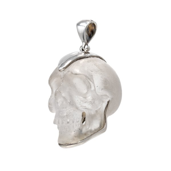 Closeup photo of Quartz Skull Pendant - Ornately Carved Skull Set In Sterling Silver Setting
