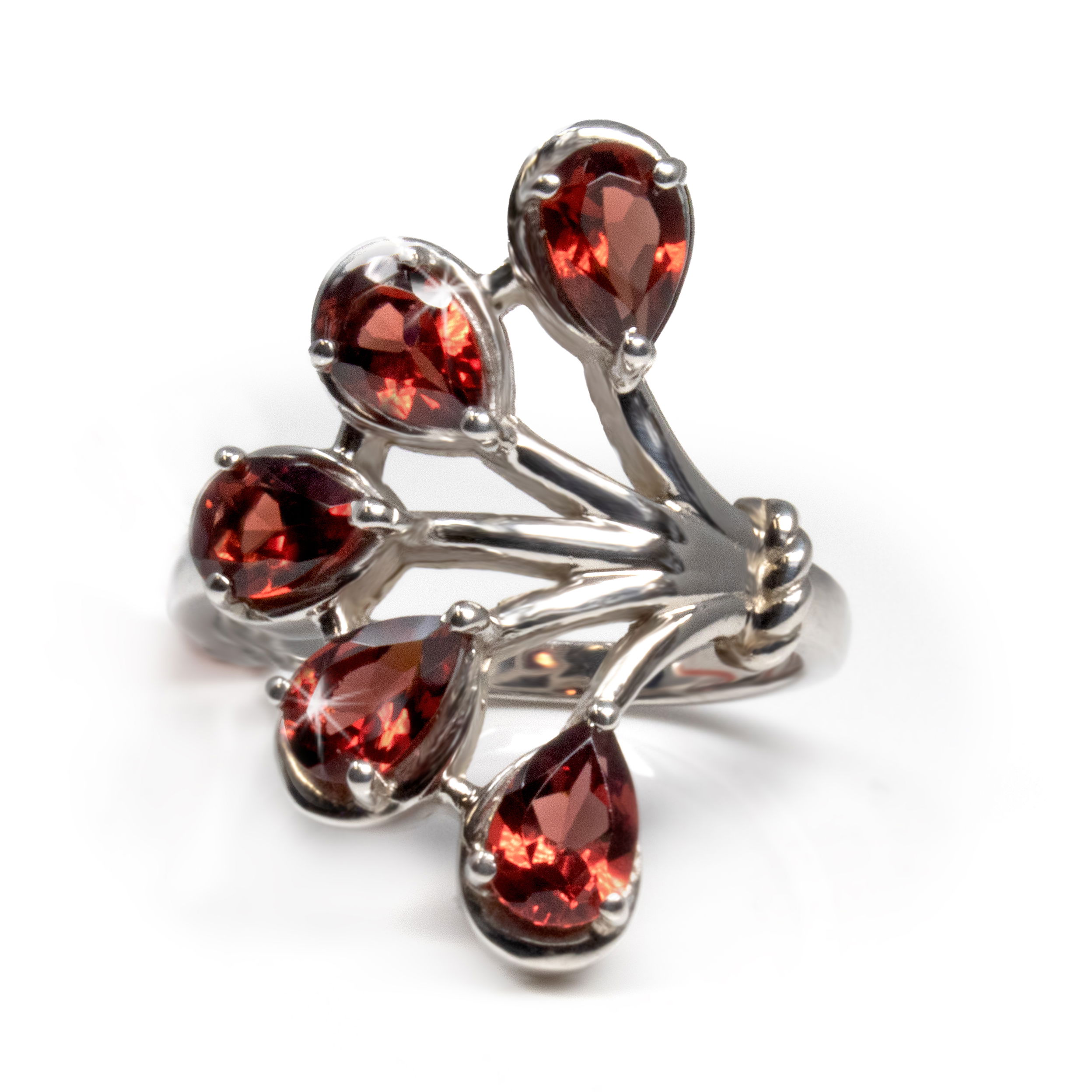 This stunning faceted garnet ring is perfect for any occasion. Crafted from 925 sterling silver, the dainty fan design features five pear-shaped garnets set in prongs. The faceted gems sparkle brightly in the light, radiating with a deep red hue that captures the beauty of the January birthstone. This delicate piece is a precious timeless piece that will be treasured for generations. Whether you're gifting a special someone or treating yourself, this rare Earth Gallery ring is one that won't disappoint. Faceted Garnet Ring Size 6 - 5 Pears Prong Set In Dainty Fan Design
