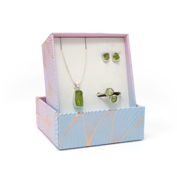 Closeup photo of Peridot Set With Necklace & Stud Earrings & Duo Ring With Open Top - Rough Freeform With Silver Bezel Size 7