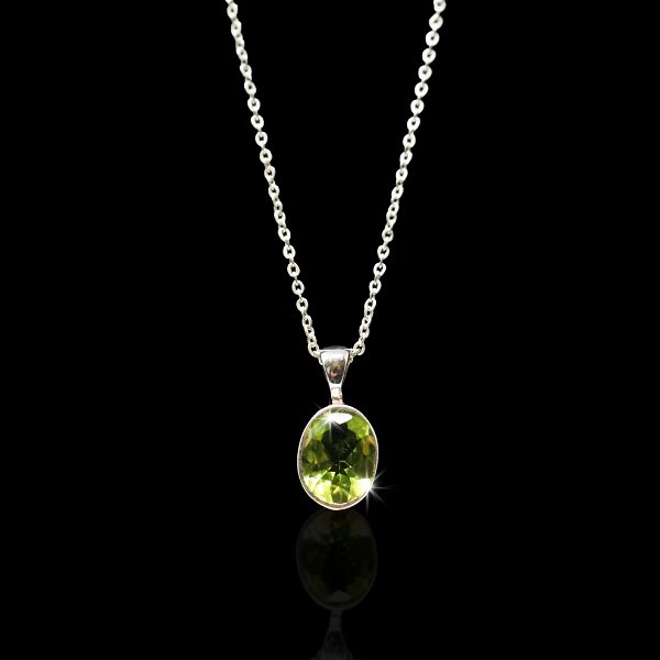 Closeup photo of Peridot Necklace - Dainty Faceted Oval With Silver Bezel