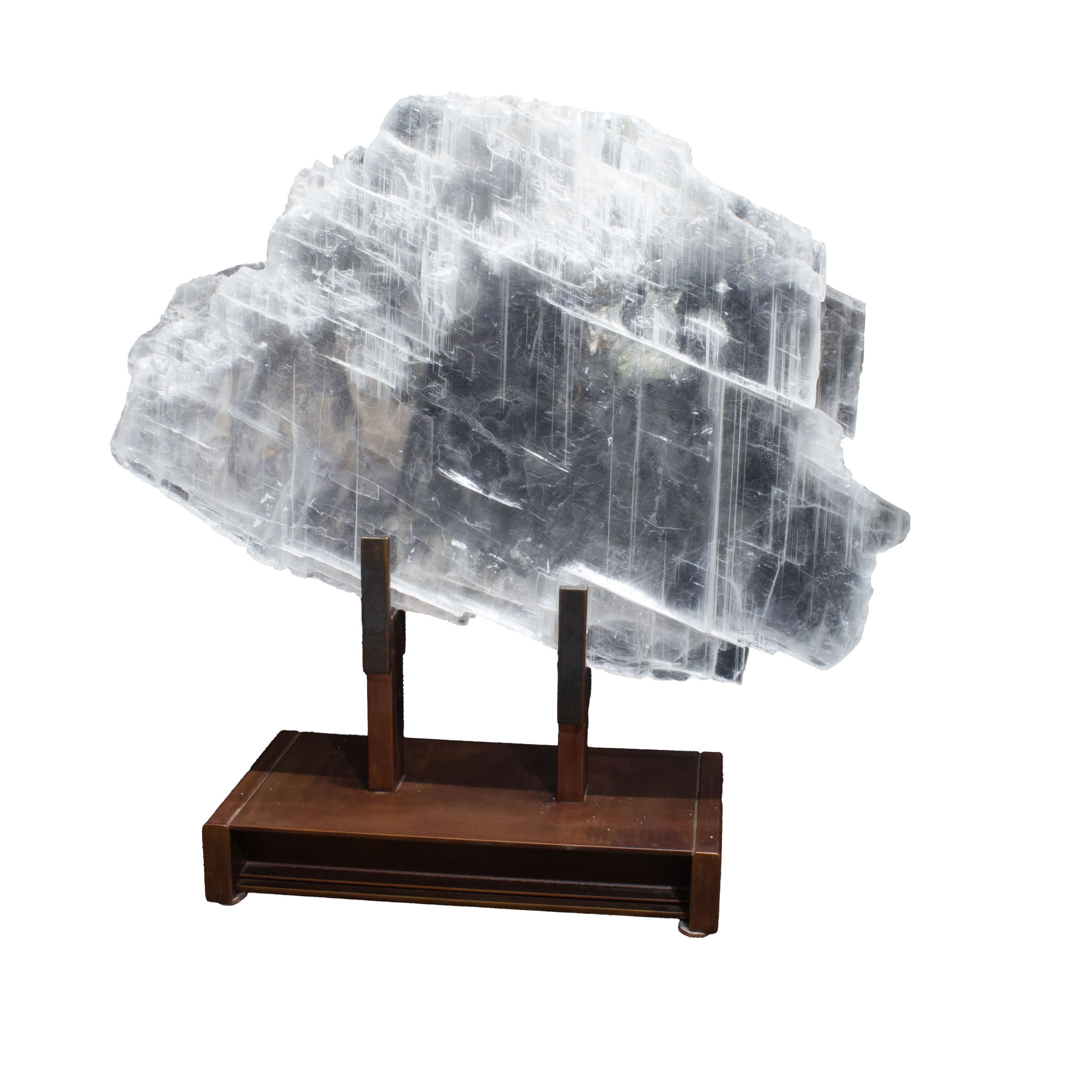 Elevate your décor and energy with this stunning Selenite Crystal on a custom stand, sourced directly from the rich mineral beds of Utah. Each specimen slice features intricate natural striations and a lustrous, pearlescent finish, making it a captivating mineral display piece. Expertly mounted on a sleek, handcrafted stand, this selenite not only showcases the stone’s ethereal beauty but also channels its legendary calming and cleansing properties. Selenite Crystal From Utah On Custom Stand