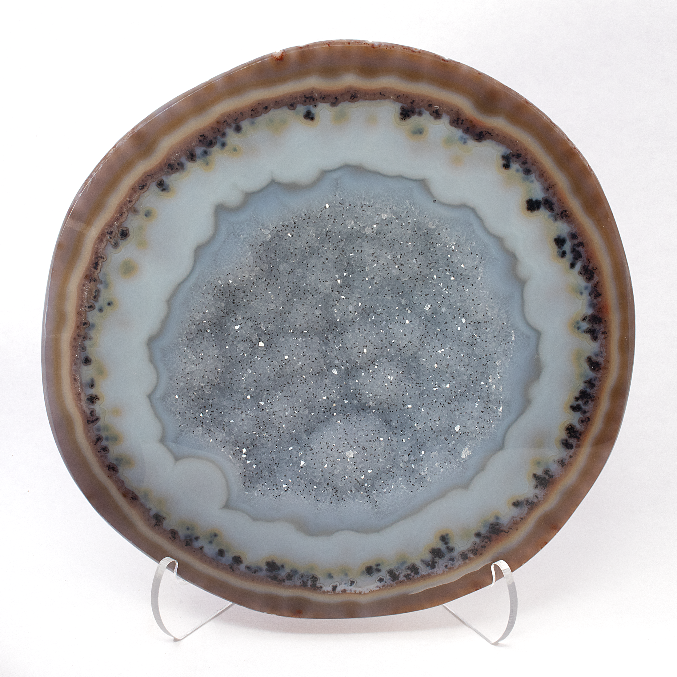 Discover the mesmerizing allure of nature's artistry with our Round Druze Agate Geode Pair. Each geode is a testament to the Earth’s intricate craftsmanship, offering a stunning display of beauty and wonder. The exterior of these geodes is skillfully polished, highlighting the enchanting periwinkle blue druze surface that captivates with its shimmering allure.These exquisite geode pairs are not just decorative pieces, but a slice of the Earth's history, crystallized in time. Round Druze Agate Geode Pair With Periwinkle Blue Druze Polished Exterior