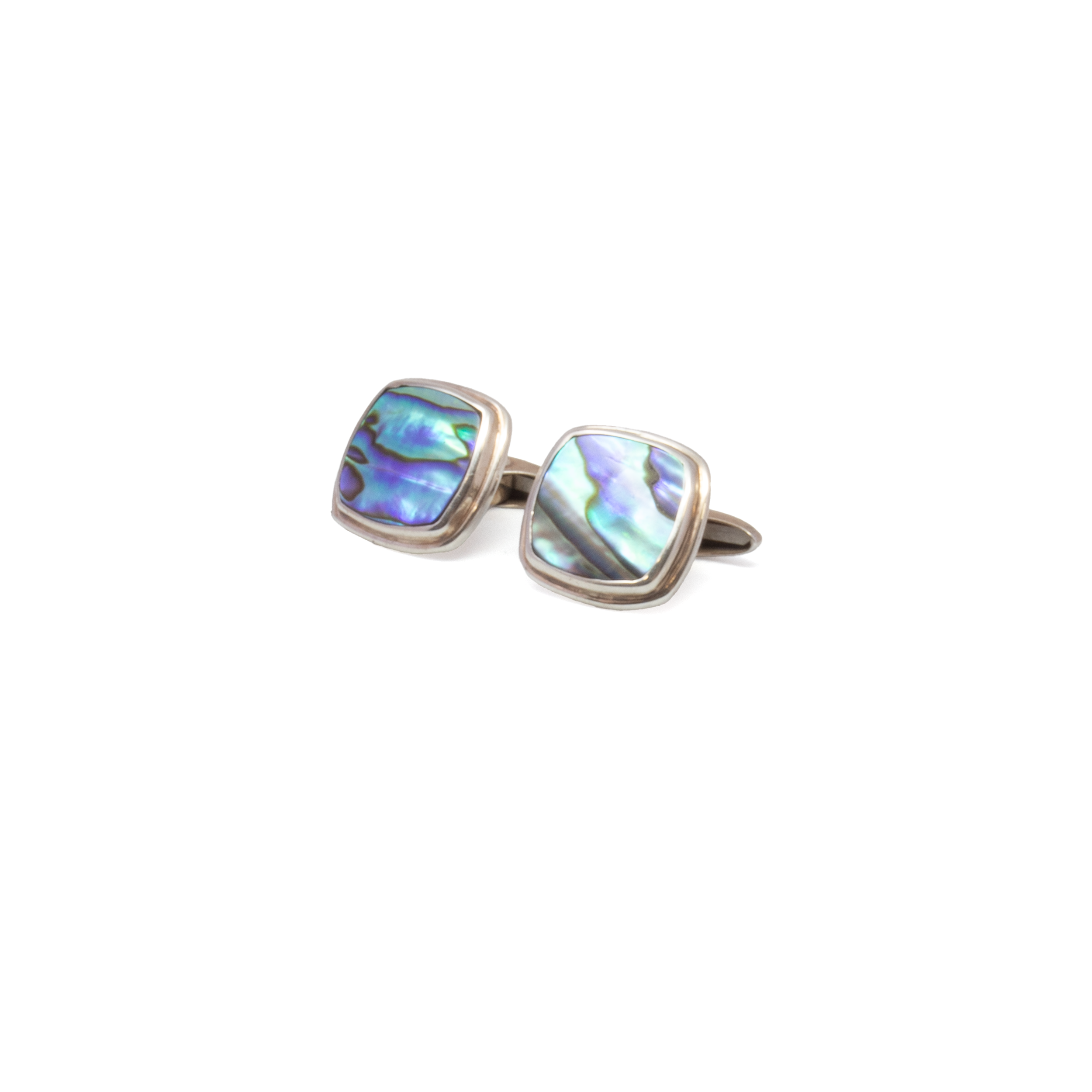 Elevate your style with these striking Abalone Cufflinks, featuring genuine Abalone shell in a refined square-round silhouette set in polished 925 sterling silver. Each cufflink reveals a vibrant play of iridescent blues, greens, and purples, making every pair a unique expression of nature’s artistry. The contemporary design balances boldness with sophistication, perfect for enhancing formalwear or adding a distinctive touch to everyday attire. A thoughtful gift or a refined personal statement, these cufflinks are crafted for the gentleman who values natural beauty and timeless craftsmanship. Abalone Cufflinks -Square Round