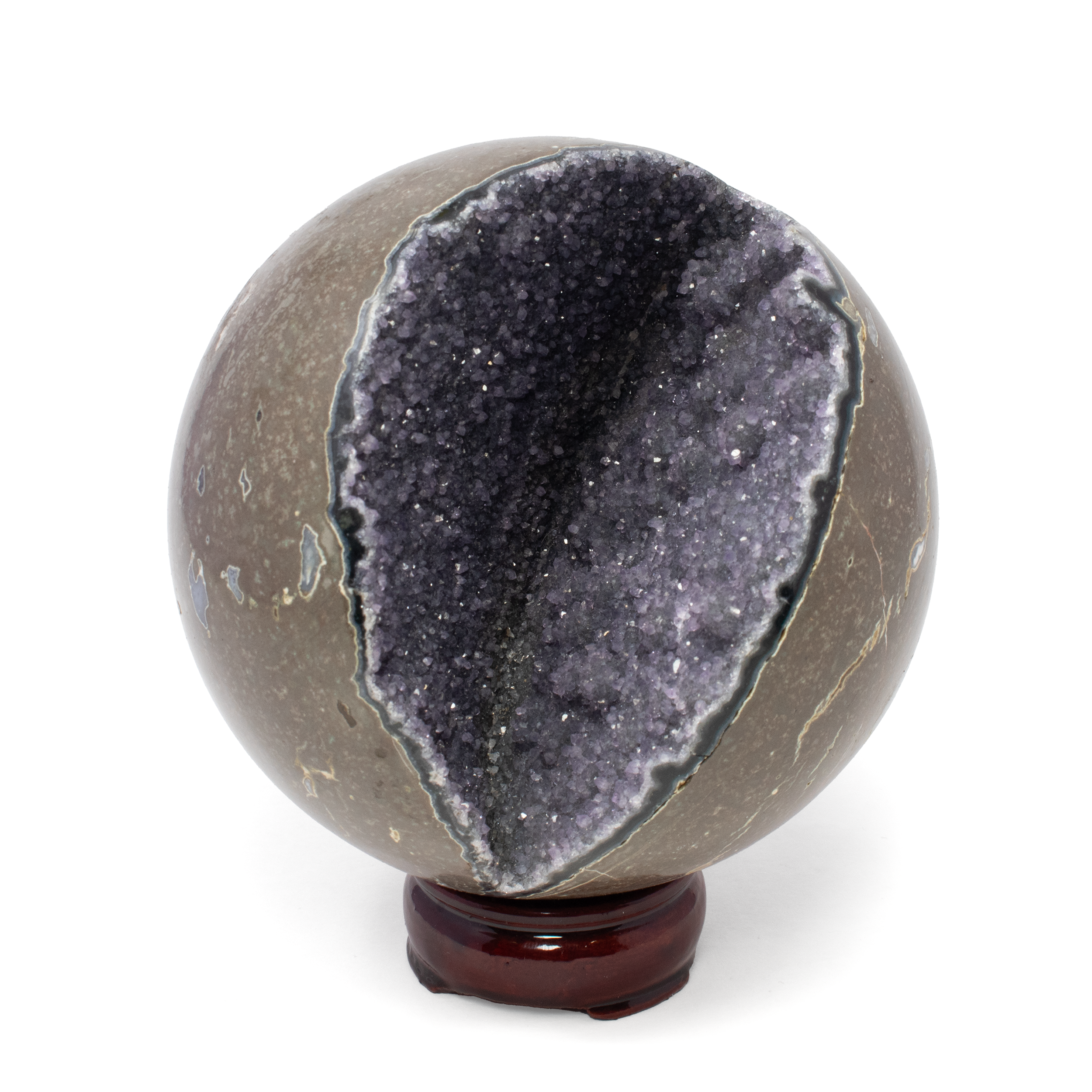 Introducing the Midnight Quartz Druze Geode Sphere with Deep Crevasse – an extraordinary specimen that captures the awe-inspiring beauty of the natural world. This remarkable piece is not just a decorative item; it's a gateway to a realm of shimmering elegance and geological wonder.Crafted by nature, this sphere boasts a mesmerizing exterior of rich, dark midnight quartz. Its allure is heightened by the intricate druze formation that blankets the surface with countless tiny crystals, each reflecting light like a galaxy of distant stars. The deep, alluring crevasse adds an element of mystery and intrigue, inviting you to gaze into its depths and lose yourself in its crystalline wonder.Perfectly spherical, this geode is a remarkable combination of art and science, created over millennia yet timeless in its appeal. It's not just a piece of earth's artistry; it's a conversation starter, a meditation aid, and a symbol of the beauty that arises from within. Midnight Quartz Druze Geode Sphere With Deep Crevasse