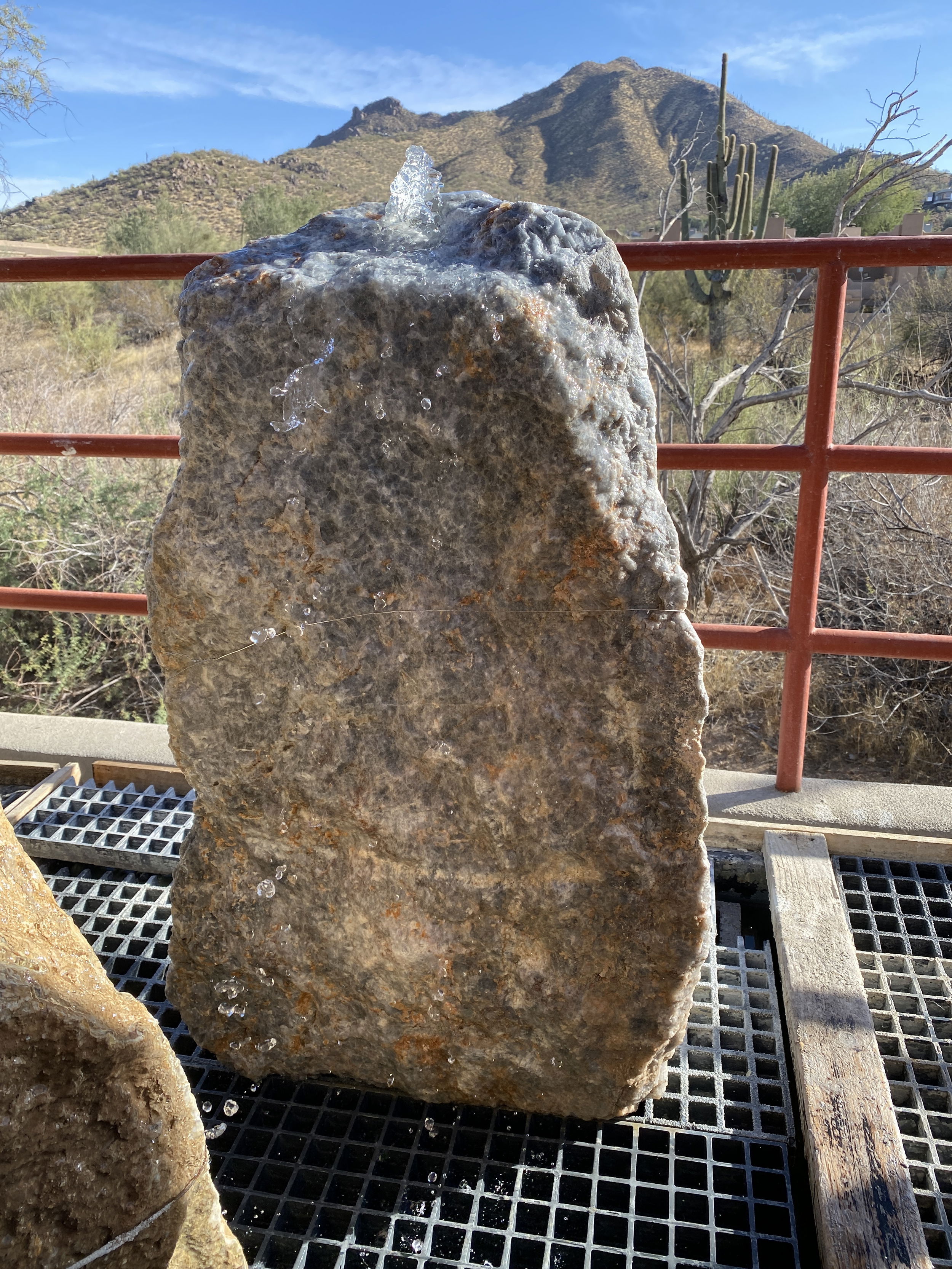 This Blue Calcite Boulder Fountain with Cut Side adds a peaceful ambiance to any outdoor space. Its elegant design enhances the aesthetic appeal of your yard, garden, or patio while creating a relaxing atmosphere. Let Rare Earth Gallery’s white-glove service make your fountain dreams come true—simply choose your fountain, tell us where it goes, and we’ll handle the rest, from delivery to installation. IMPORTANT: the purchase price listed is for the FOUNTAIN ONLY and DOES NOT INCLUDE the cost of a basin, pump, parts or installation. Before purchasing a fountain online, we STRONGLY recommend you call us at (480) 575-4360 for a FREE consultation to discuss these additional costs and schedule a pre-site inspection. Also, free shipping does NOT apply to fountains, please call for a quote. Blue Calcite Boulder Fountain With Cut Side