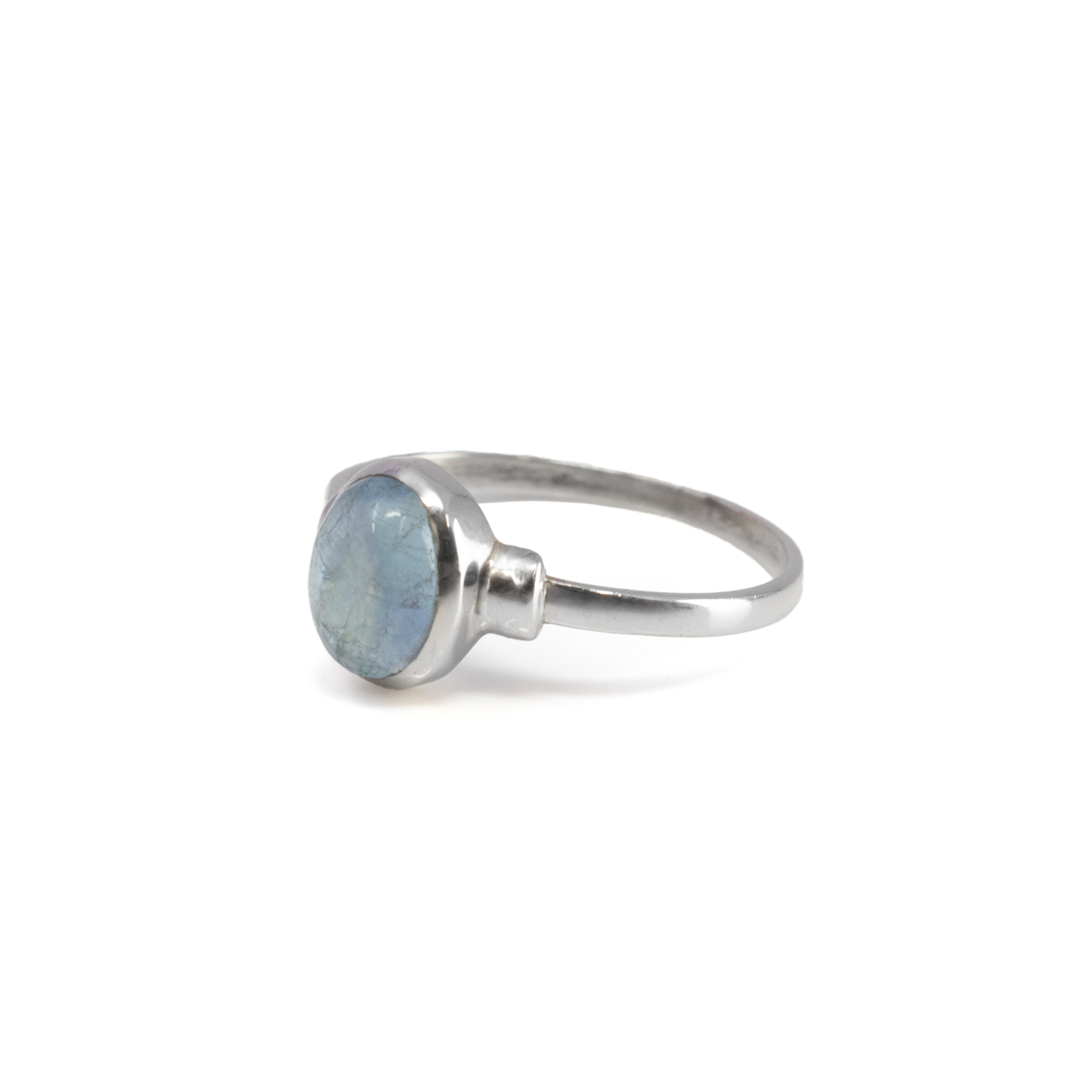 Elevate your jewelry collection with this exquisite Aquamarine Ring, a true embodiment of elegance and sophistication. Meticulously crafted, this captivating piece is designed to capture attention and leave a lasting impression. At the heart of this masterpiece is a genuine oval-shaped aquamarine gemstone, known for its mesmerizing blue hue reminiscent of tranquil ocean waters. This precious gem exudes a serene yet captivating aura, making it a perfect choice for those who appreciate the beauty of nature. The aquamarine is securely nestled in an elegant bezel setting, offering both modern aesthetics and robust protection. This setting keeps the gem secure, ensuring longevity and durability without compromising on style. Aquamarine Ring - Bezel Set Oval On Step Shoulder Detail Band Sz 10.5