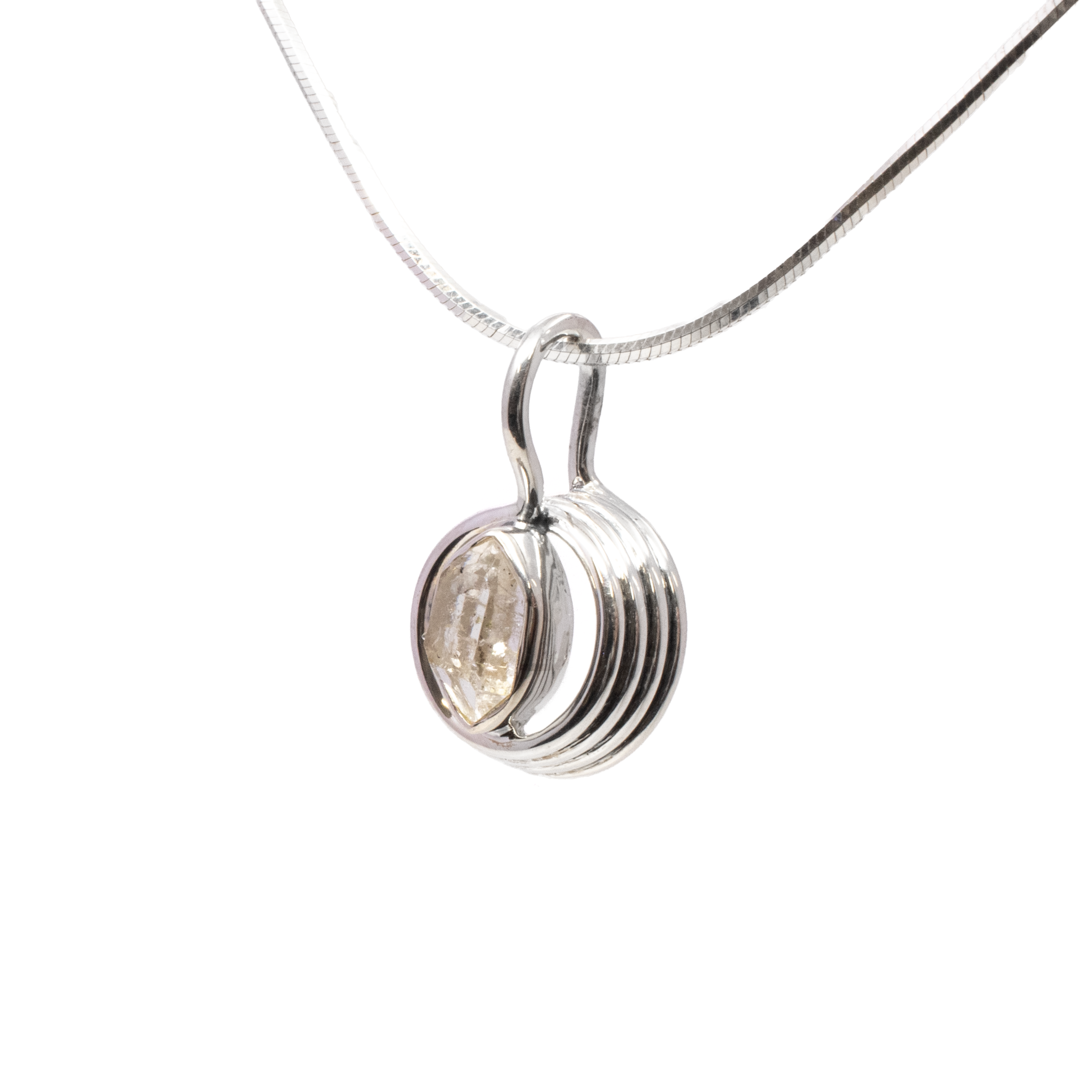 Introducing our exquisite Herkimer Diamond Pendant, a stunning fusion of natural beauty and artisanal craftsmanship. This captivating piece features a faceted freeform Herkimer Diamond, renowned for its exceptional clarity and natural brilliance. Each Herkimer Diamond is unique, showcasing nature's handiwork through its organic shape and delicate inclusions that catch and reflect light beautifully.Encased in a luxurious 925 sterling silver bezel setting, the pendant's bold design is elevated further by a tall spiral detail that adds a contemporary flair and enhances the stone’s elegance. The high-quality sterling silver provides a durable and lustrous frame that complements the Herkimer Diamond’s pristine sparkle. Herkimer Diamond Pendant - Faceted Freeform With 925 Sterling Silver Bezel Set On Tall Spiral