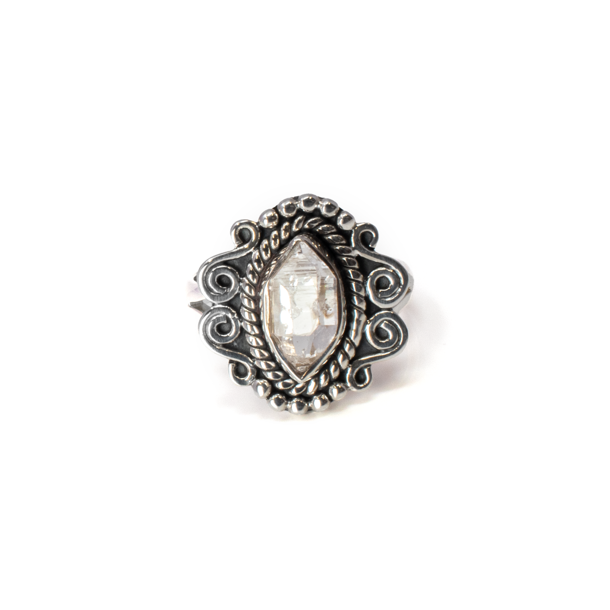 Introducing our exquisite Herkimer Diamond Ring, a stunning piece that epitomizes elegance and uniqueness. This remarkable gemstone ring features a faceted freeform Herkimer diamond, renowned for its exceptional clarity and natural brilliance. Nestled in a delicate 925 sterling silver setting, the diamond is encircled by a meticulously crafted rope bezel that accentuates its lustrous beauty. Adding to its charm, the ring is embellished with intricate beading on top, offering a touch of sophistication and texture. The sides of the ring showcase exquisite filigree work, a testament to fine craftsmanship that enhances its vintage allure. Sized at 7, this statement piece is designed to fit comfortably and draw admiration at any occasion. Herkimer Diamond Ring - Faceted Freeform With 925 Sterling Silver Rope Bezel & Beading On Top With Filigree On Sides Sz7