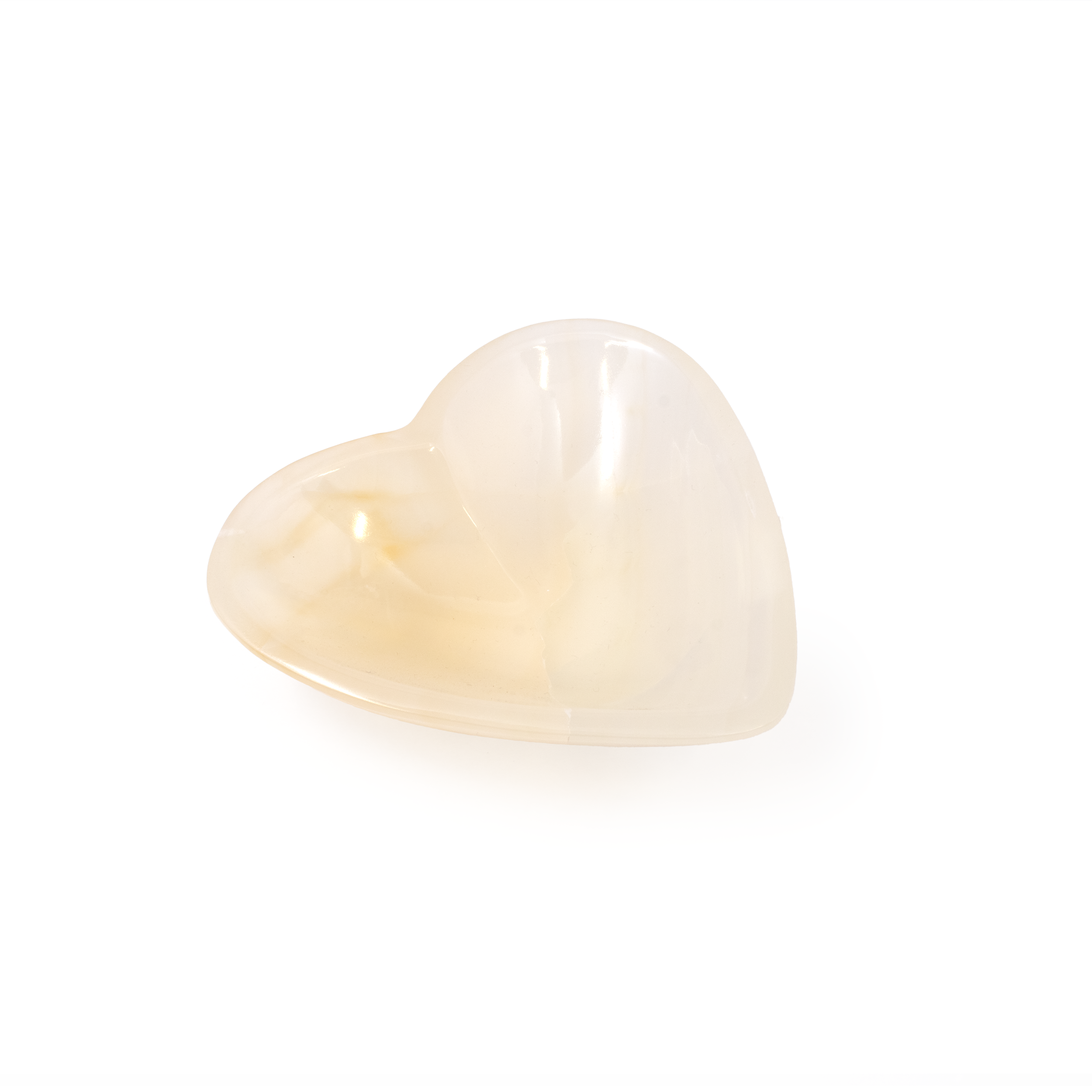 Introducing the Pearlescent Onyx Heart Vessel, a captivating piece that combines the mystical allure of Mexican Onyx with the timeless symbol of love. This exquisite heart-shaped vessel showcases the enchanting pearlescent qualities of onyx, with its shimmering layers and intricate patterns that captivate the eye and the imagination.Each Pearlescent Onyx Heart Vessel is meticulously crafted by skilled artisans, ensuring that no two pieces are exactly alike. The natural beauty of onyx is highlighted in this elegant form, with its rich, swirling hues of black, white, and grey, accented by hints of earthy warmth. This makes it a perfect addition to any home or office, whether as a standalone decorative piece or as a unique container for holding cherished items. Pearlescent Onyx Heart Vessel