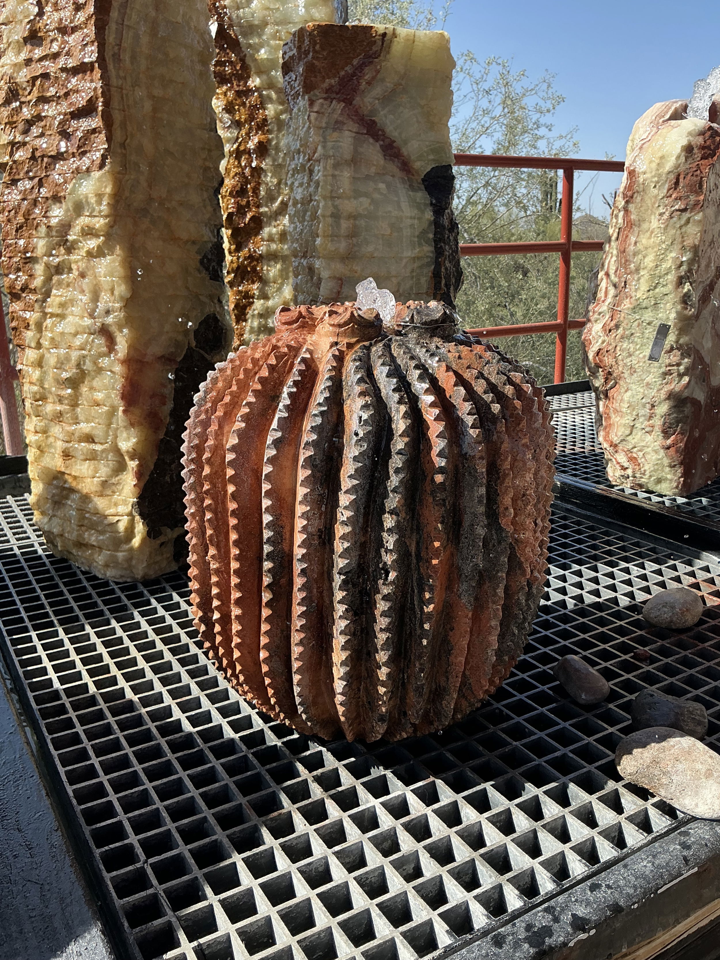 Introducing the Travertine Barrel Cactus Fountain, a stunning masterpiece that seamlessly combines the beauty of nature with the elegance of finely crafted art. As water cascades gently over the contours of the cactus, it creates a serene ambiance, perfect for relaxation and meditation. The soothing sound of flowing water complements any space it inhabits. Whether you're an art enthusiast, a nature lover, or simply someone who appreciates fine décor, this fountain is sure to elevate your surroundings and inspire tranquility. Let Rare Earth Gallery’s white-glove service make your fountain dreams come true—simply choose your fountain, tell us where it goes, and we’ll handle the rest, from delivery to installation. IMPORTANT: the purchase price listed is for the FOUNTAIN ONLY and DOES NOT INCLUDE the cost of a basin, pump, parts or installation. Before purchasing a fountain online, we STRONGLY recommend you call us at (480) 575-4360 for a FREE consultation to discuss these additional costs and schedule a pre-site inspection. Also, free shipping does NOT apply to fountains, please call for a quote. Travertine Barrel Cactus Fountain