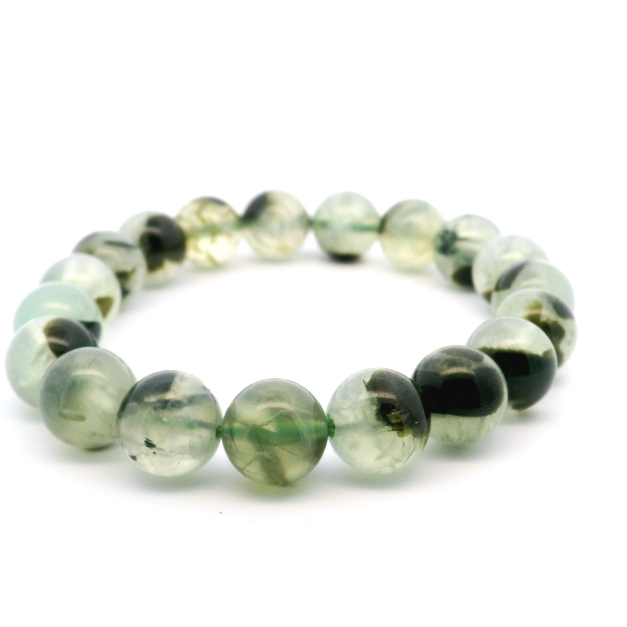 Elevate your style with the Prehnite Beaded Bracelet, featuring smooth 10–12mm beads accented by striking epidote inclusions that reveal nature’s unique artistry. The soft green hues and intricate mineral patterns make each bracelet truly one-of-a-kind, blending effortlessly into any jewelry collection. Perfect for stacking or wearing alone, this piece invites harmony and tranquility into your daily wear or special occasions, adding a meaningful touch to your curated bracelet stack. Prehnite Beaded Bracelet with Epidote Inclusions 10mm - 12mm