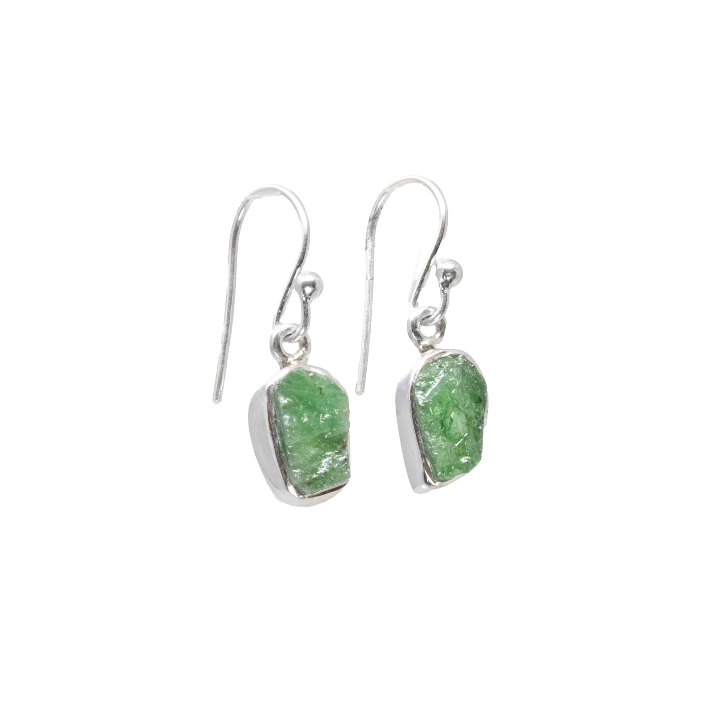 Introducing our exquisite Emerald Dangle Earrings, a perfect blend of natural elegance and timeless sophistication. These captivating earrings feature rough freeform emerald gemstones, each uniquely shaped to celebrate their natural beauty. Set in 925 sterling silver bezels, the rich green tones of the emeralds are beautifully complemented by the gleaming silver, creating an eye-catching contrast that will elevate any ensemble.Crafted with meticulous attention to detail, these gemstone earrings are designed for those who appreciate the allure of nature combined with high-quality craftsmanship. The dangle style adds a touch of playful movement, ensuring these earrings catch the light and sparkle with every turn of your head. With the durability and hypoallergenic properties of 925 sterling silver, you can enjoy these earrings comfortably all day long. Emerald Dangle Earrings - Rough Freeform with 925 Sterling Silver Bezel
