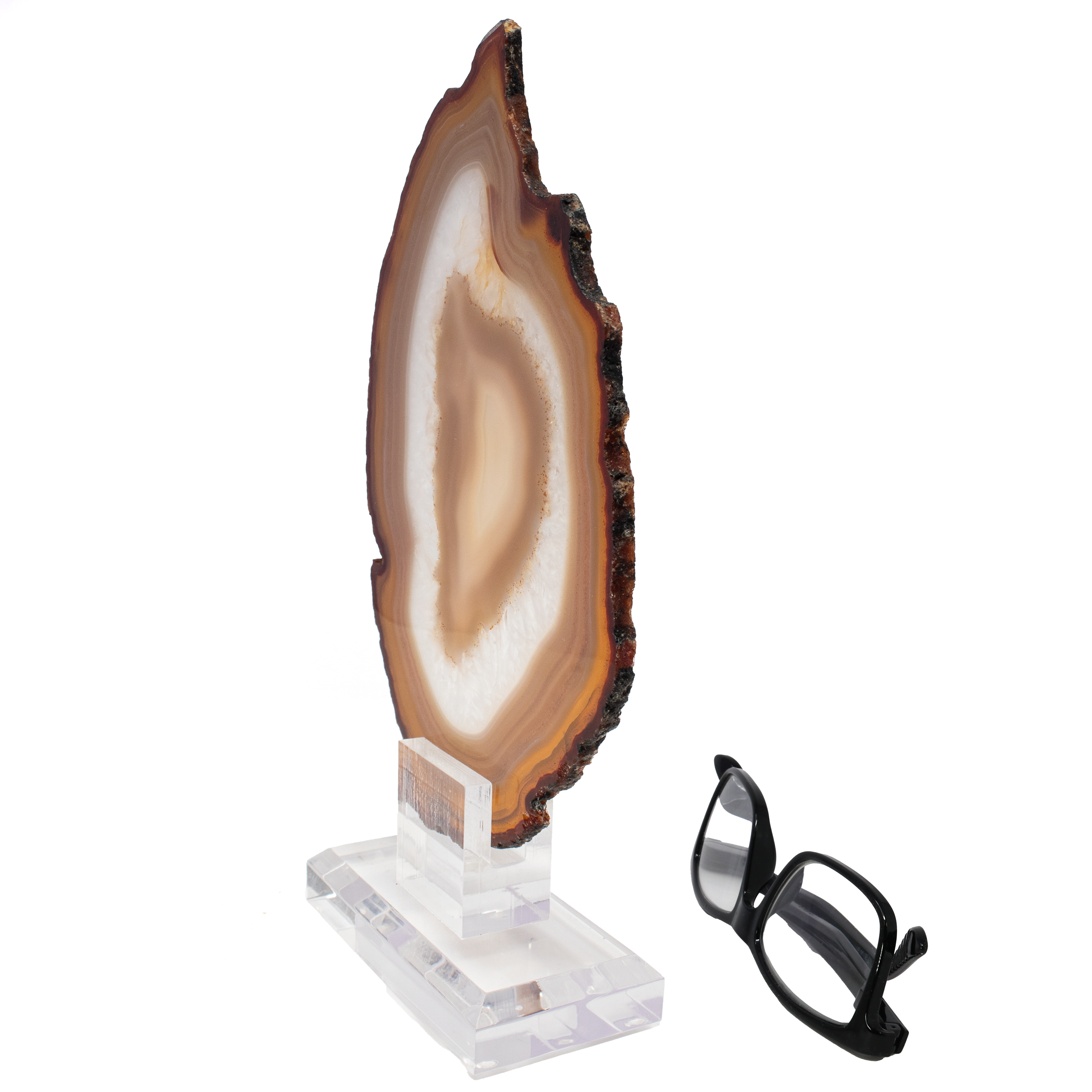 Introducing our exquisite Agate Slice on Screw Stand with Carnelians & Quartz in Flame Shape – a stunning masterpiece that seamlessly blends natural elegance with artistic craftsmanship. This unique decor piece is perfect for collectors, crystal enthusiasts, or anyone looking to add a touch of natural beauty to their home or office.Crafted from high-quality agate, this slice displays the mesmerizing bands and patterns characteristic of this captivating mineral. The addition of vibrant carnelians and radiant quartz enhances its beauty, highlighting the harmonious fusion of colorful hues and textures. Inspired by the dynamic and organic form of a flame, this artistic piece captures attention instantly. The elegant contours and fluid lines make it a striking focal point in any setting, evoking a sense of warmth, energy, and movement.Expertly polished on both sides, this agate slice gleams with sophistication. The double-sided polish ensures that the intricate details and rich colors are visible from every angle, making it a versatile display piece. Agate Slice on Screw Stand with Carnelians & Quartz in Flame Shape