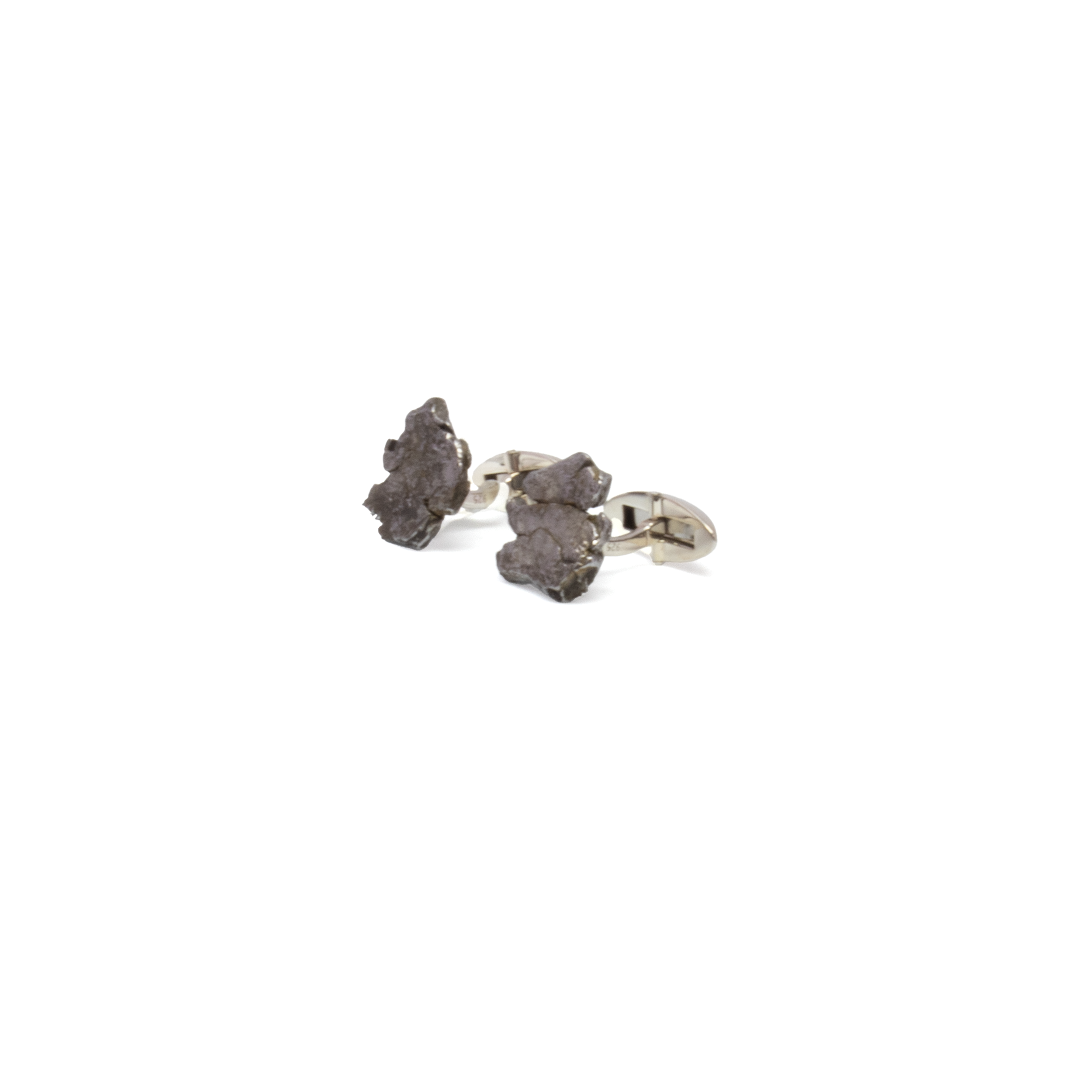 Elevate your style with these extraordinary Campo de Cielo Meteorite Nugget Cufflinks, meticulously handcrafted to feature authentic fragments of the ancient Argentinian meteorite. Each cufflink showcases a raw, naturally textured nugget—millions of years old—set in polished 925 sterling silver, blending celestial origin with refined craftsmanship. A striking fusion of rarity and elegance, these cufflinks are perfect for astronomy enthusiasts, collectors of rare gemstones, or anyone drawn to meaningful, statement-making accessories. Presented in a luxurious gift box, they make an unforgettable gift for life’s most exceptional moments. Campo De Cielo Meteorite Nugget Cufflinks with 925 Sterling Silver Clasp