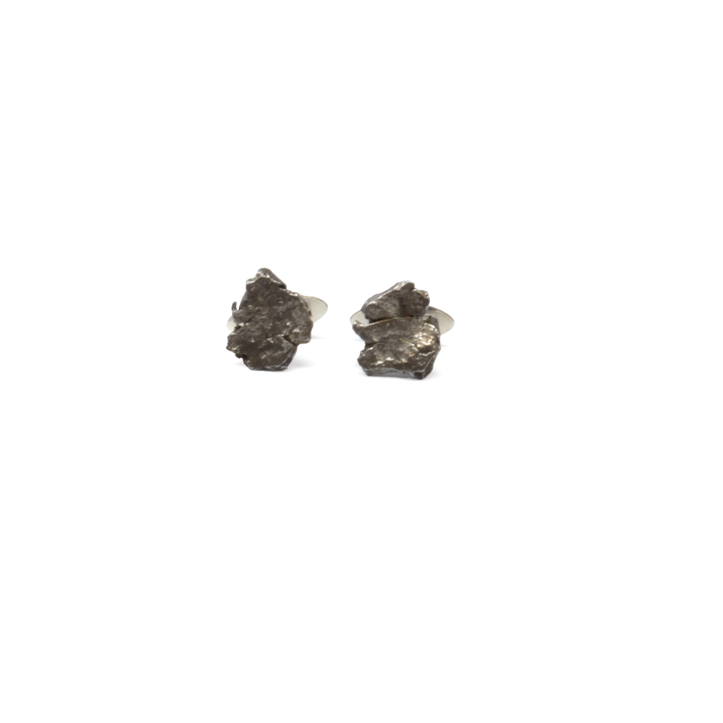 Elevate your formalwear with these exceptional Campo del Cielo Meteorite Nugget Cufflinks, featuring genuine meteorite fragments set in sleek 925 sterling silver. Each cufflink holds a naturally formed Campo del Cielo meteorite—sourced from Argentina’s famed impact site—offering a tangible piece of cosmic history. The raw texture of the meteorite contrasts beautifully with the polished silver clasp, blending rugged authenticity with refined design. A striking accessory for collectors, astronomy lovers, or anyone drawn to the extraordinary, these cufflinks bring the universe to your sleeve with timeless sophistication. Campo De Cielo Meteorite Nugget Cufflinks with 925 Sterling Silver Clasp