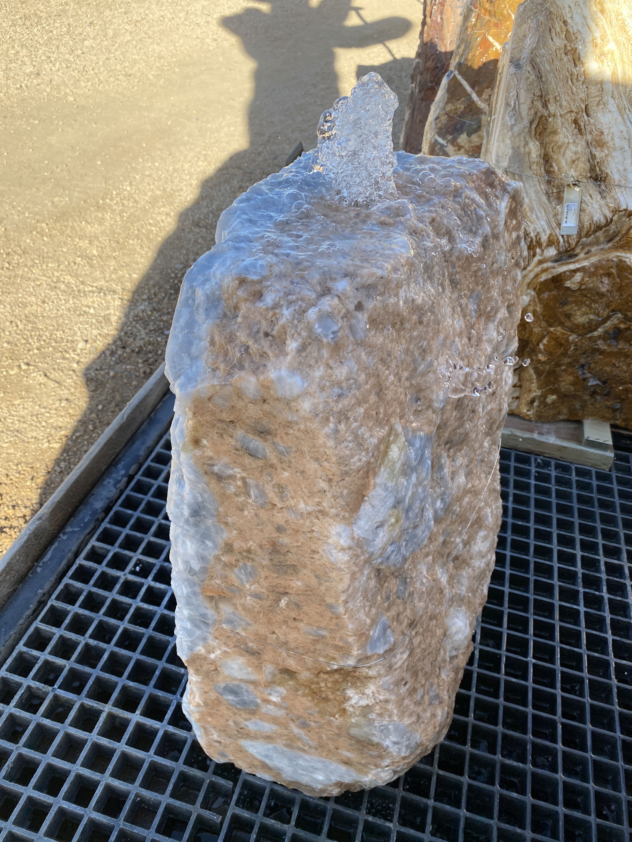 This Blue Calcite Fountain enhances tranquility and aesthetics in your yard, garden, or patio, bringing a sense of calmness and beauty to your outdoor space. Its unique blue calcite composition creates a soothing and visually appealing focal point. Let Rare Earth Gallery’s white-glove service make your fountain dreams come true—simply choose your fountain, tell us where it goes, and we’ll handle the rest, from delivery to installation. IMPORTANT: the purchase price listed is for the FOUNTAIN ONLY and DOES NOT INCLUDE the cost of a basin, pump, parts or installation. Before purchasing a fountain online, we STRONGLY recommend you call us at (480) 575-4360 for a FREE consultation to discuss these additional costs and schedule a pre-site inspection. Also, free shipping does NOT apply to fountains, please call for a quote. Blue Calcite Onyx Fountain - 2 Cut Sides