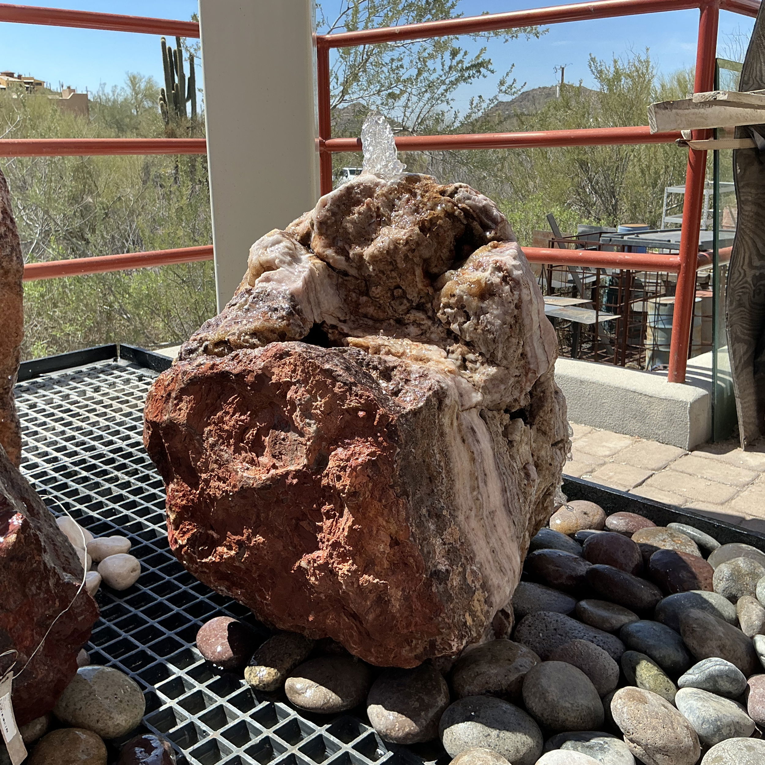 The Rosa Onyx Boulder Fountain showcases the mesmerizing hues and unique veining of Mexican Onyx, renowned for its delicate interplay of rose, cream, and amber tones that create a warm, inviting, and peaceful atmosphere. Experience the tranquil sound of water cascading over the smooth surface of the onyx boulder. The gentle flow creates a peaceful atmosphere, making it an ideal focal point for relaxation and meditation. Let Rare Earth Gallery’s white-glove service make your fountain dreams come true—simply choose your fountain, tell us where it goes, and we’ll handle the rest, from delivery to installation. IMPORTANT: the purchase price listed is for the FOUNTAIN ONLY and DOES NOT INCLUDE the cost of a basin, pump, parts or installation. Before purchasing a fountain online, we STRONGLY recommend you call us at (480) 575-4360 for a FREE consultation to discuss these additional costs and schedule a pre-site inspection. Also, free shipping does NOT apply to fountains, please call for a quote. Rosa Onyx Boulder Fountain