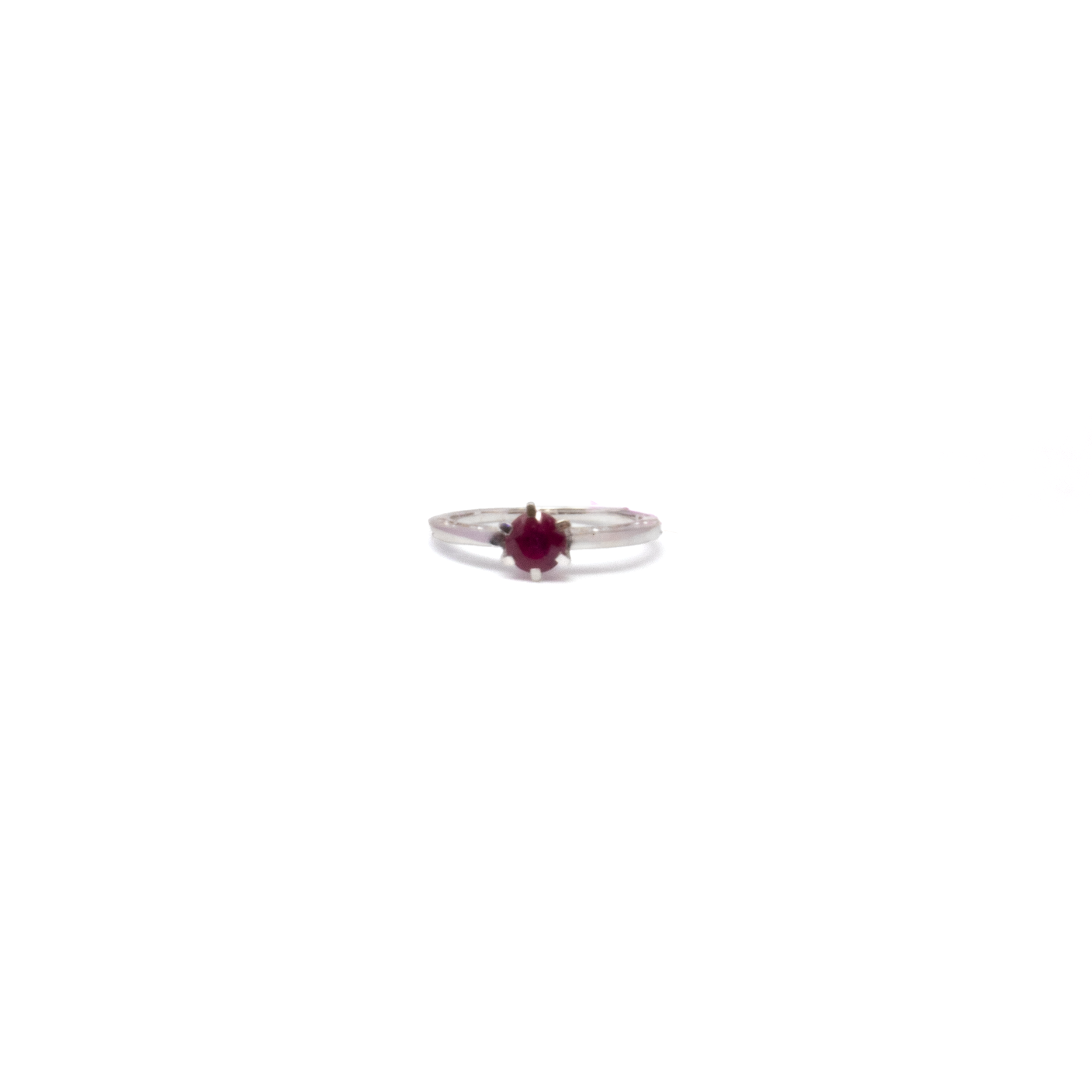 Boldly radiant, this Ruby Ring commands attention with a fiery faceted round ruby set high in a striking 925 sterling silver band. Intricate filigree work weaves a story of vintage elegance and modern edge, creating a dynamic contrast that draws the eye. Sized 5 for a perfect fit, this ring is for those who dare to wear passion and refinement on their finger—a true statement of fearless style. Ruby Ring - Faceted Round Prong Set on 925 Sterling Silver Band with Cutout Filigree sz5