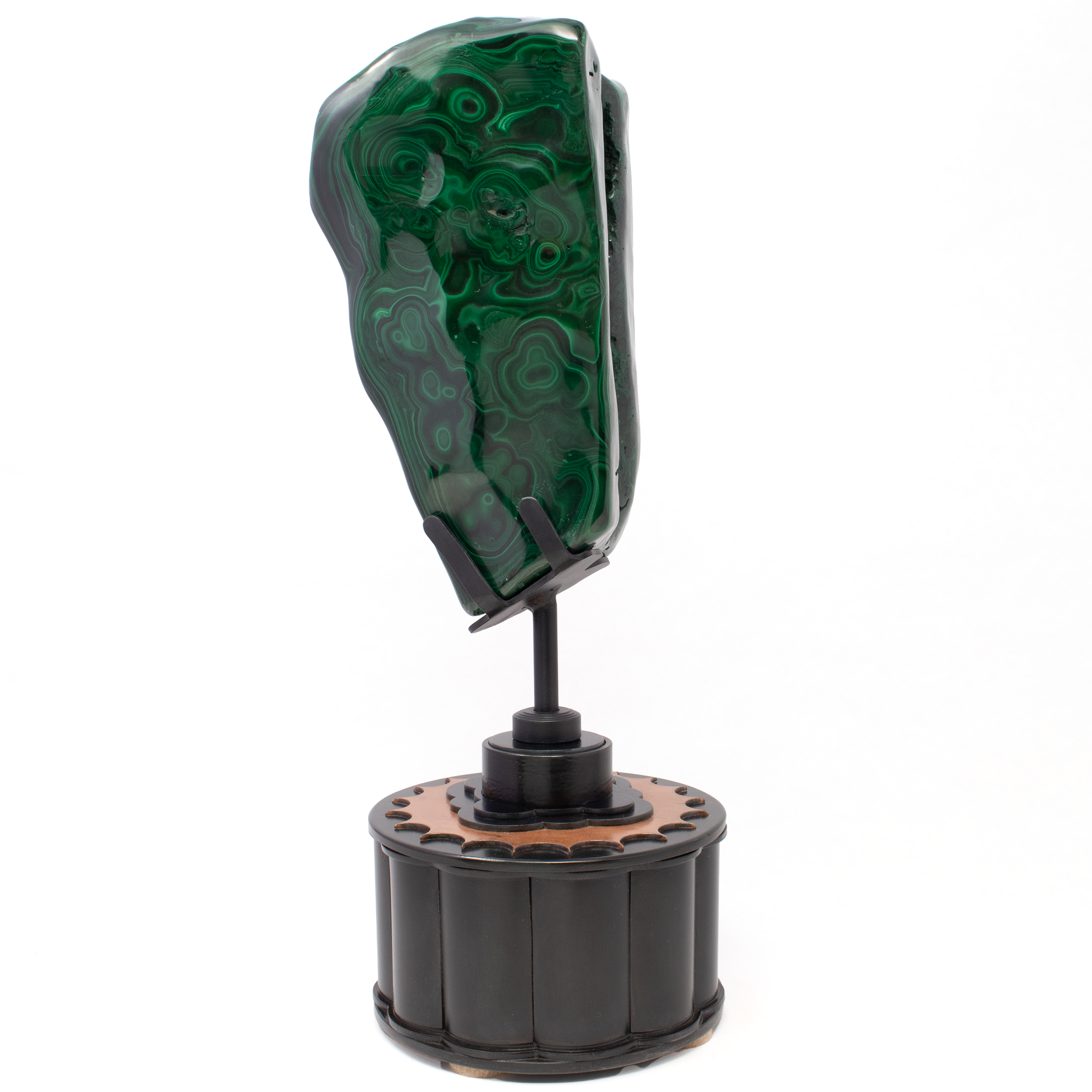 Elevate your space with the mesmerizing allure of our Freeform Polished Malachite on a Rotating Round Custom Stand. This exquisite piece is more than a decorative item; it's a testament to the natural beauty and captivating patterns formed over centuries. Freeform Polished Malachite on Rotating Round Custom Stand - Natural Crevasse in Wedge and Striking Eye Patterns with 2 -Tone Copper Cog Design
