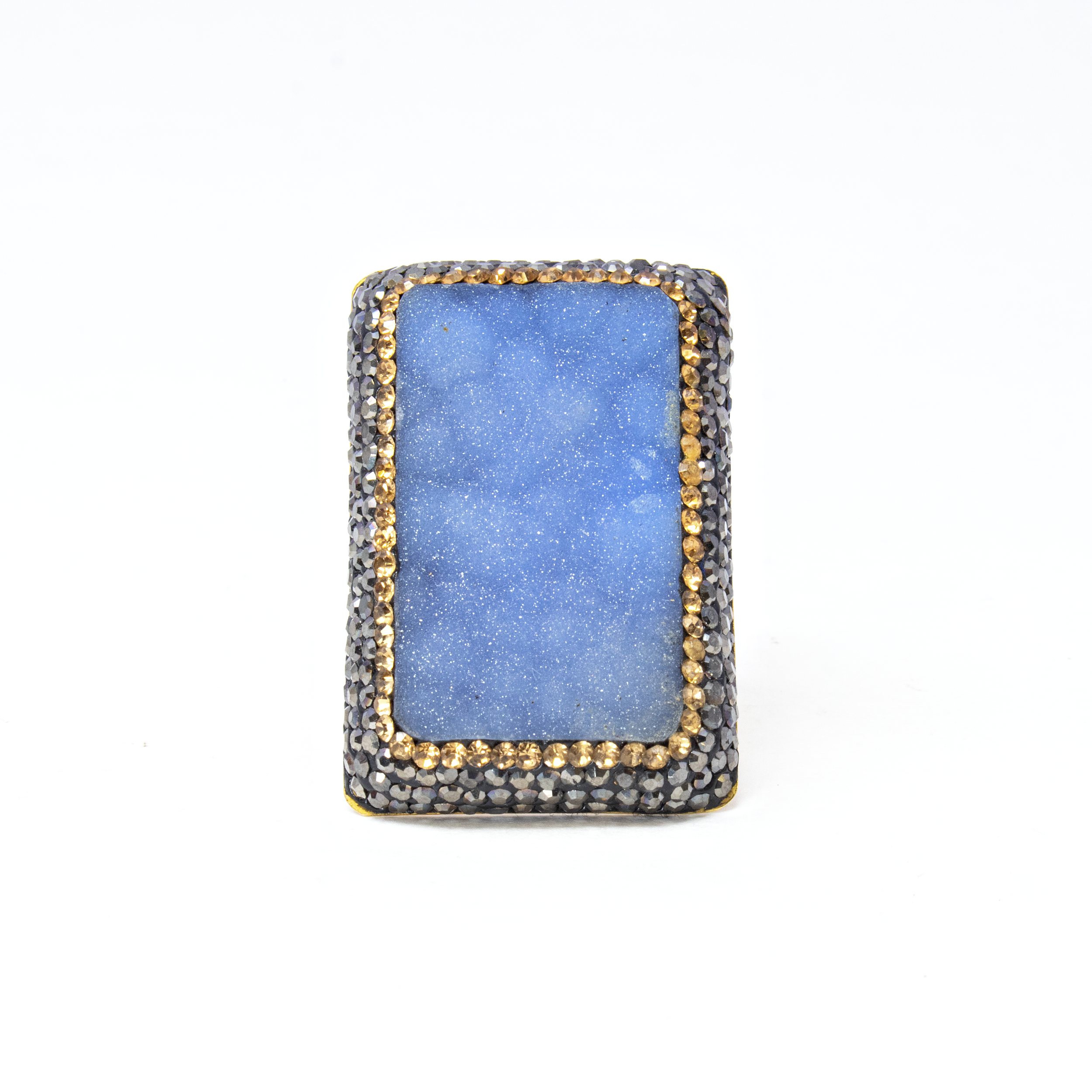 Introducing the Natural Blue Druze Ring - a stunning statement piece that effortlessly combines the elegance of natural gemstones with contemporary design. This exquisite ring features a captivating rectangular blue druze centerpiece, known for its brilliant sparkle and unique texture that captures the essence of the ocean's depths.The druze is beautifully accentuated by shimmering gold crystals that add a touch of opulence and sophistication. Delicate marcasite detailing surrounds the druze, adding an antique charm to this modern masterpiece. Crafted from high-quality 925 sterling silver, the ring is expertly plated in gold, ensuring lasting shine and durability. Natural Blue Druze Ring -Rectangle With Gold Crystals & Marcasite Szadj
