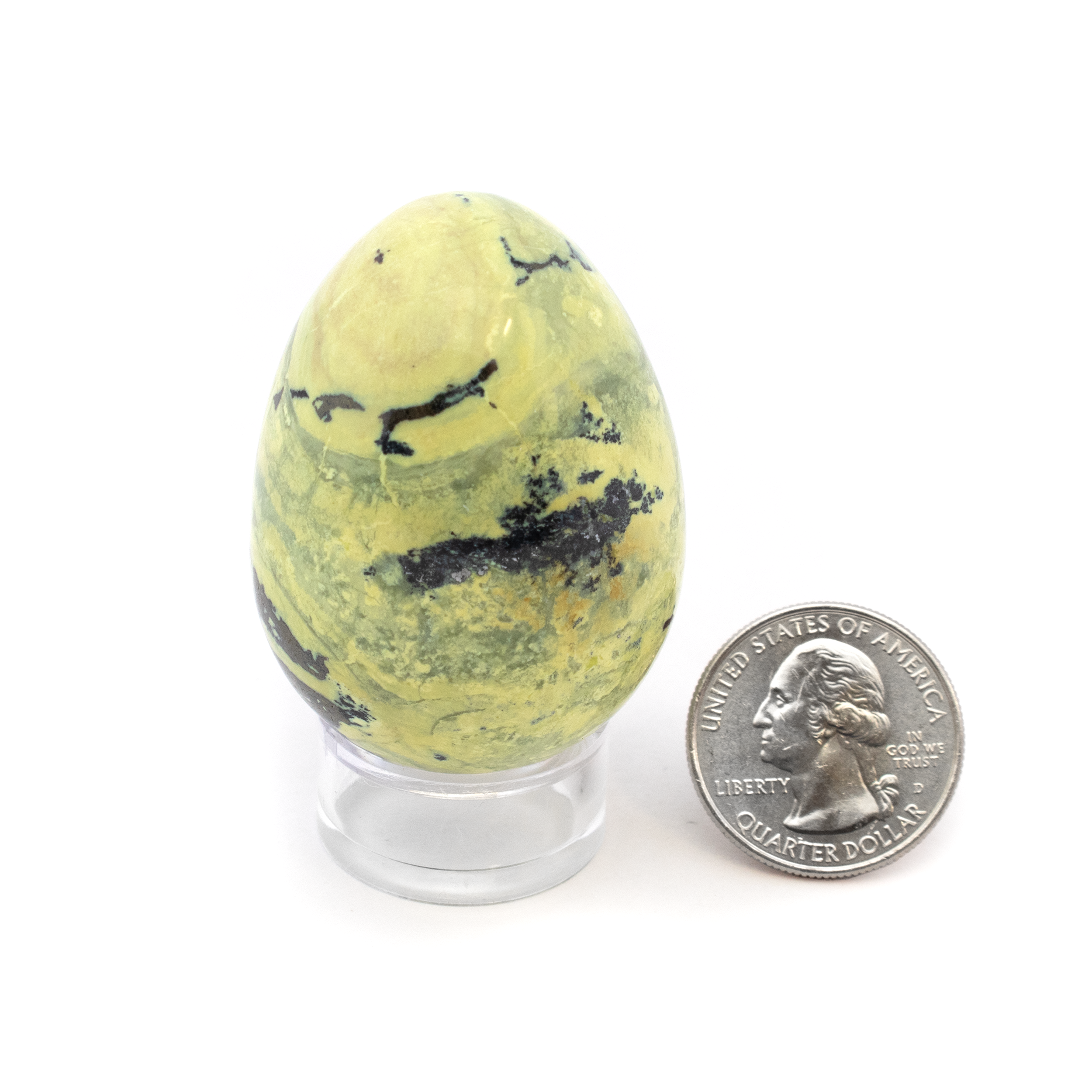 Transform your space with a touch of natural elegance and intrigue with our Serpentine Egg with Pyrite Inclusions. Sourced from the mystical terrains of Peru, this exquisite piece is more than just a decorative item—it's a testament to the wonders of Mother Earth. This captivating egg is crafted from serpentine, a mineral known for its stunning array of green shades and subtle patterns. Embedded within are pyrite inclusions, adding a distinctive sparkle that catches the eye from every angle. Serpentine is often associated with rejuvenation and protection, believed to aid in meditation and spiritual exploration. The addition of pyrite, also known as “Fool’s Gold,” is thought to bring prosperity and ward off negative energy. Serpentine Egg with Pyrite Inclusions on Lucite Stand from Peru
