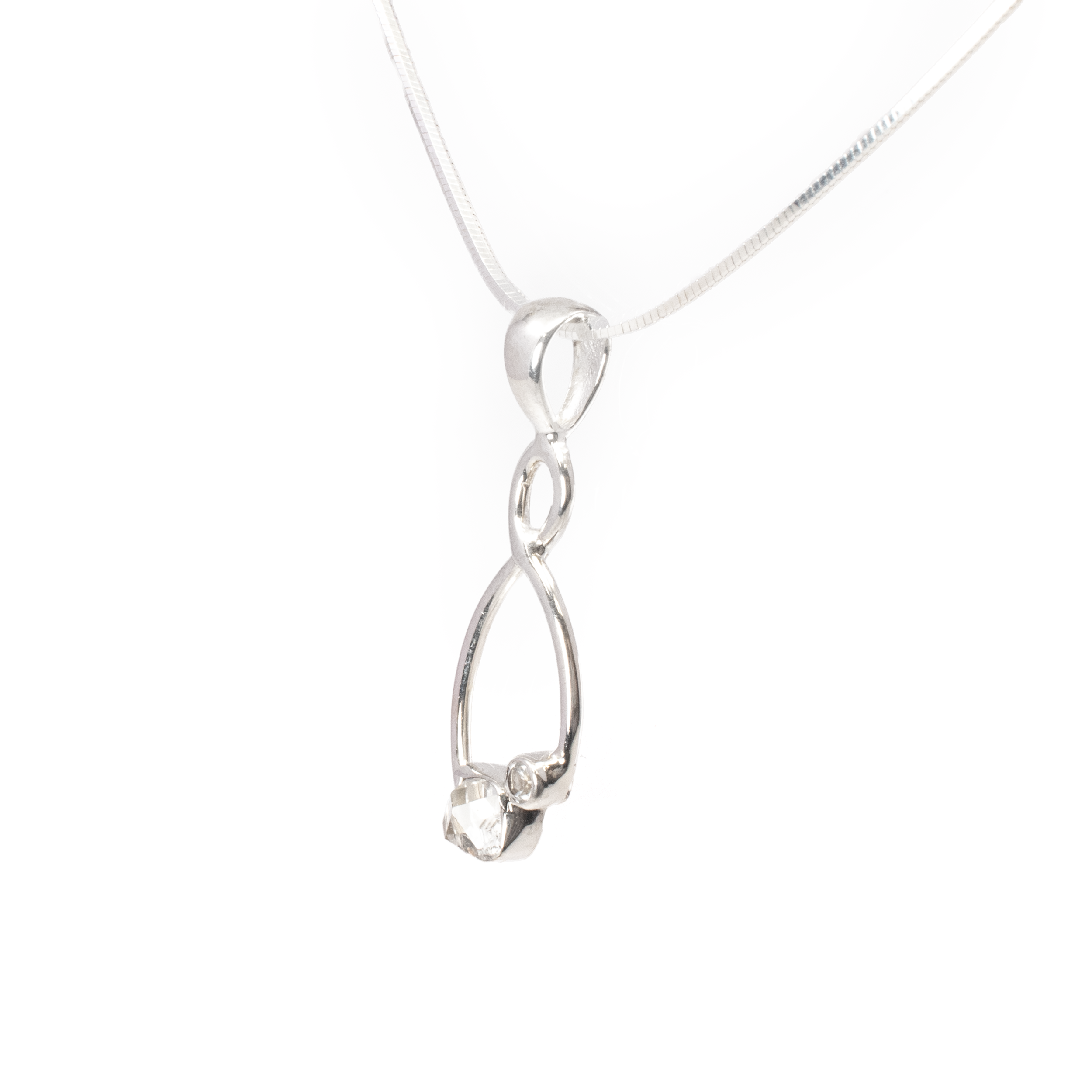 Elevate your jewelry collection with the exquisite Herkimer Diamond Pendant. This breathtaking piece features a unique freeform Herkimer Diamond that captures the ethereal beauty of natural gemstones. Each Herkimer Diamond is celebrated for its exceptional clarity and natural faceting, making every pendant one-of-a-kind.Complementing the Herkimer Diamond is a meticulously faceted round Quartz, adding a dazzling sparkle that beautifully contrasts with the raw elegance of the diamond. Both gemstones are gracefully set in a sophisticated wishbone design crafted from high-quality 925 sterling silver, known for its durability and lustrous shine. Herkimer Diamond Pendant - Freeform with Faceted Quartz Round Set on 925 Sterling Silver Wishbone