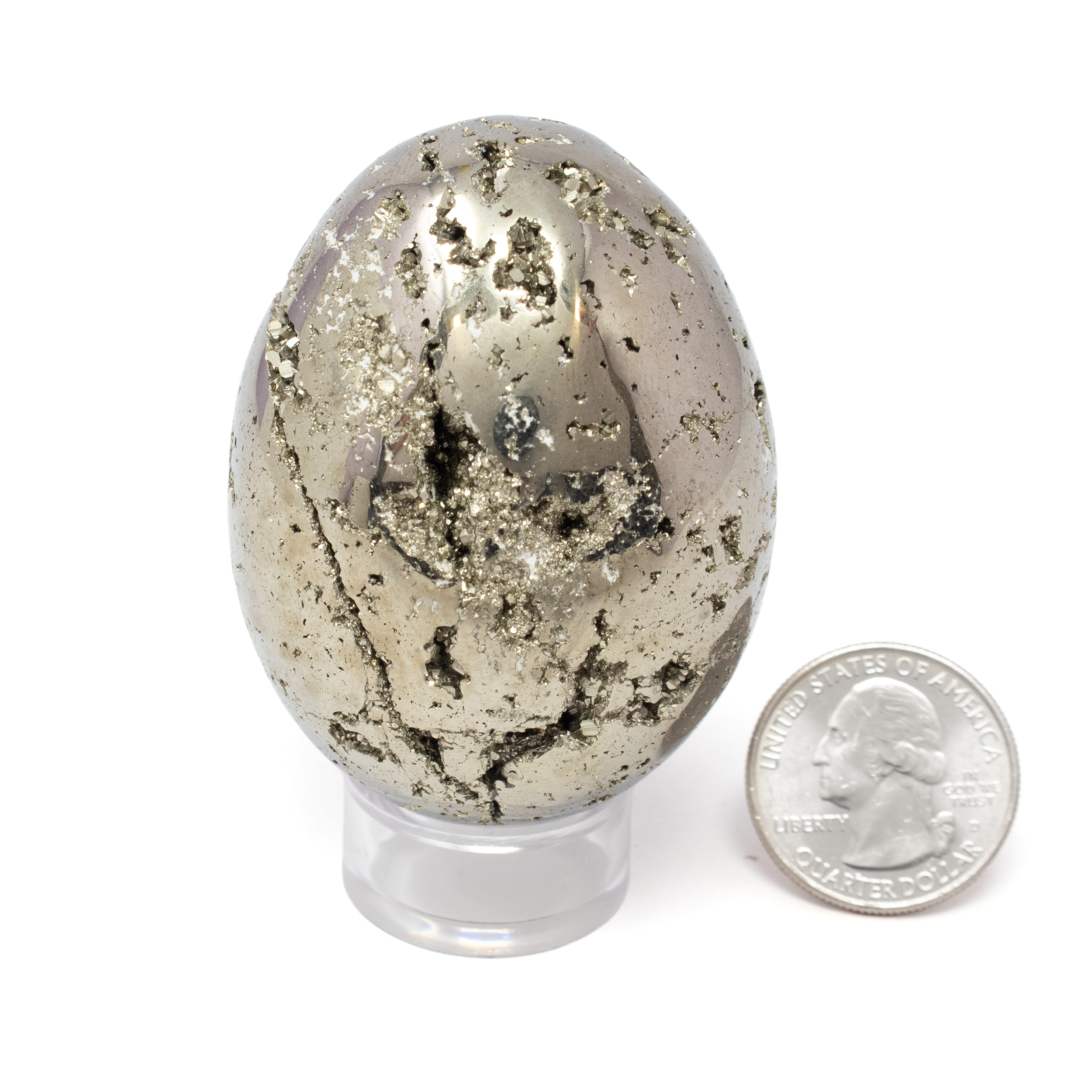 Unveil the captivating allure of nature's artistic handiwork with our exquisite Peruvian Pyrite Egg, a shimmering testament to the Earth’s geological wonders. This mesmerizing mineral specimen, flawlessly carved into a smooth egg shape, is sourced from the rich and storied landscapes of Peru, a region renowned for producing some of the world's finest Pyrite.The Peruvian Pyrite Egg dazzles with its natural metallic luster, displaying golden hues that captivate the eye and illuminate any space. Each facet of the egg reflects light in a unique dance, reminiscent of precious metals. Peruvian Pyrite Egg with Lucite Stand