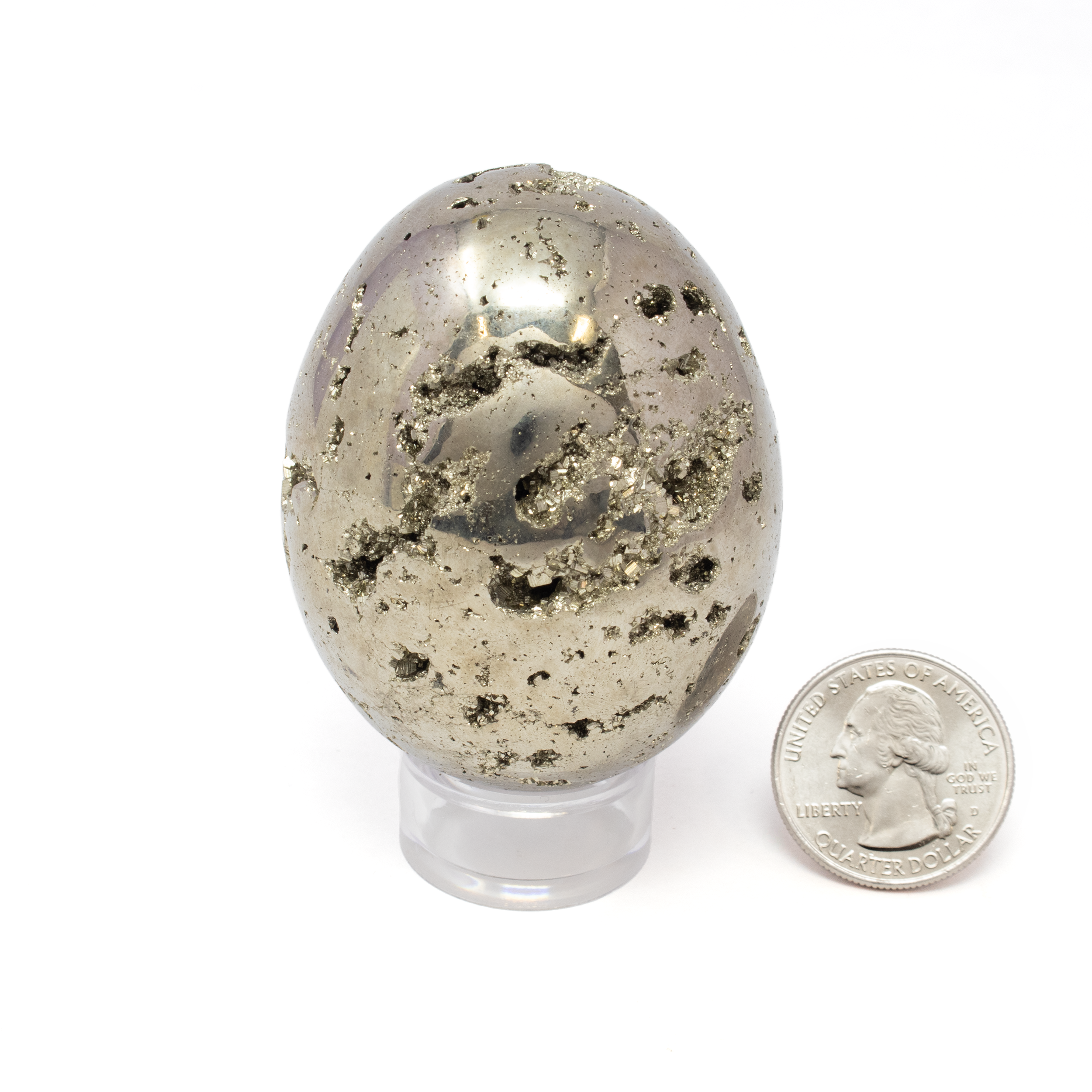 Introducing the exquisite **Peruvian Pyrite Egg with Lucite Stand** – a captivating addition to any collection of fine minerals and an elegant piece of natural art. This stunning egg-shaped sculpture, expertly crafted from authentic Peruvian pyrite, is not only a symbol of prosperity and protection but also a testament to the earth's raw beauty.The lustrous, metallic surface of the pyrite egg glistens with a rich gold hue, reminiscent of sunlight dancing on the surface, and its intricate, naturally formed geometric patterns invite you to explore its depths. Known as "Fool's Gold" for its striking resemblance to the precious metal, pyrite has long been admired for its protective and grounding qualities, believed to shield against negative energies and inspire creativity and confidence. Peruvian Pyrite Egg with Lucite Stand