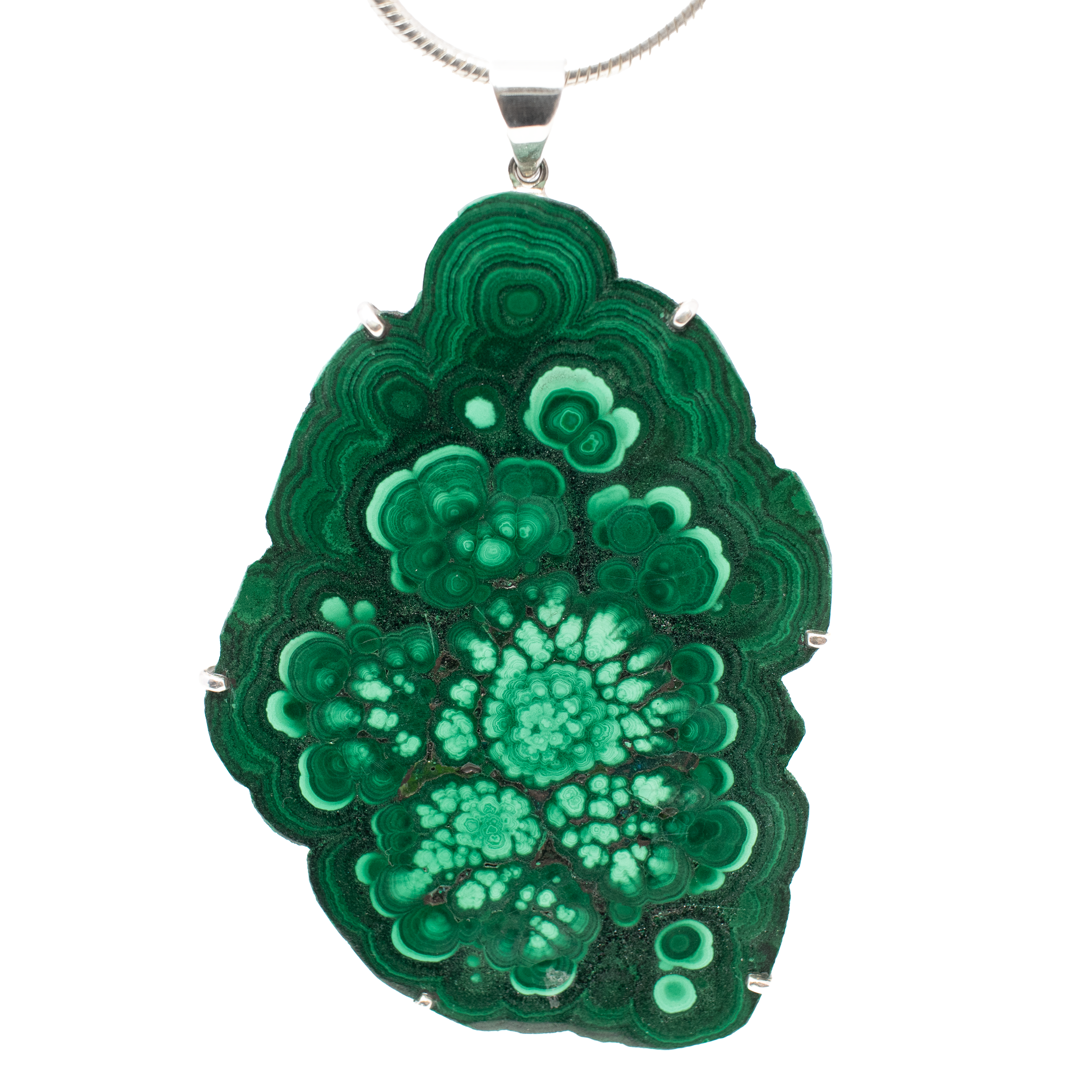 Make a bold style statement with our exquisite Malachite Pendant, a captivating piece that combines natural beauty and artisanal craftsmanship. This pendant features a unique botyroidal slice of malachite, celebrated for its organic edge and mesmerizing flowering banding. The intricate bands showcase a stunning interplay of light and dark green hues, reminiscent of lush forest landscapes and serene botanical gardens.Each malachite slice is carefully prong set in high-quality 925 sterling silver, adding a touch of elegance and ensuring durability. The contrast between the vibrant greens of the malachite and the gleaming silver setting enhances the overall allure, making this piece a standout addition to any jewelry collection. Malachite Pendant - Statement Botyroidal Slice with Organic Edge & Flowering Banding with Light & Dark Green Hues - Prong Set with 925 Sterling Silver