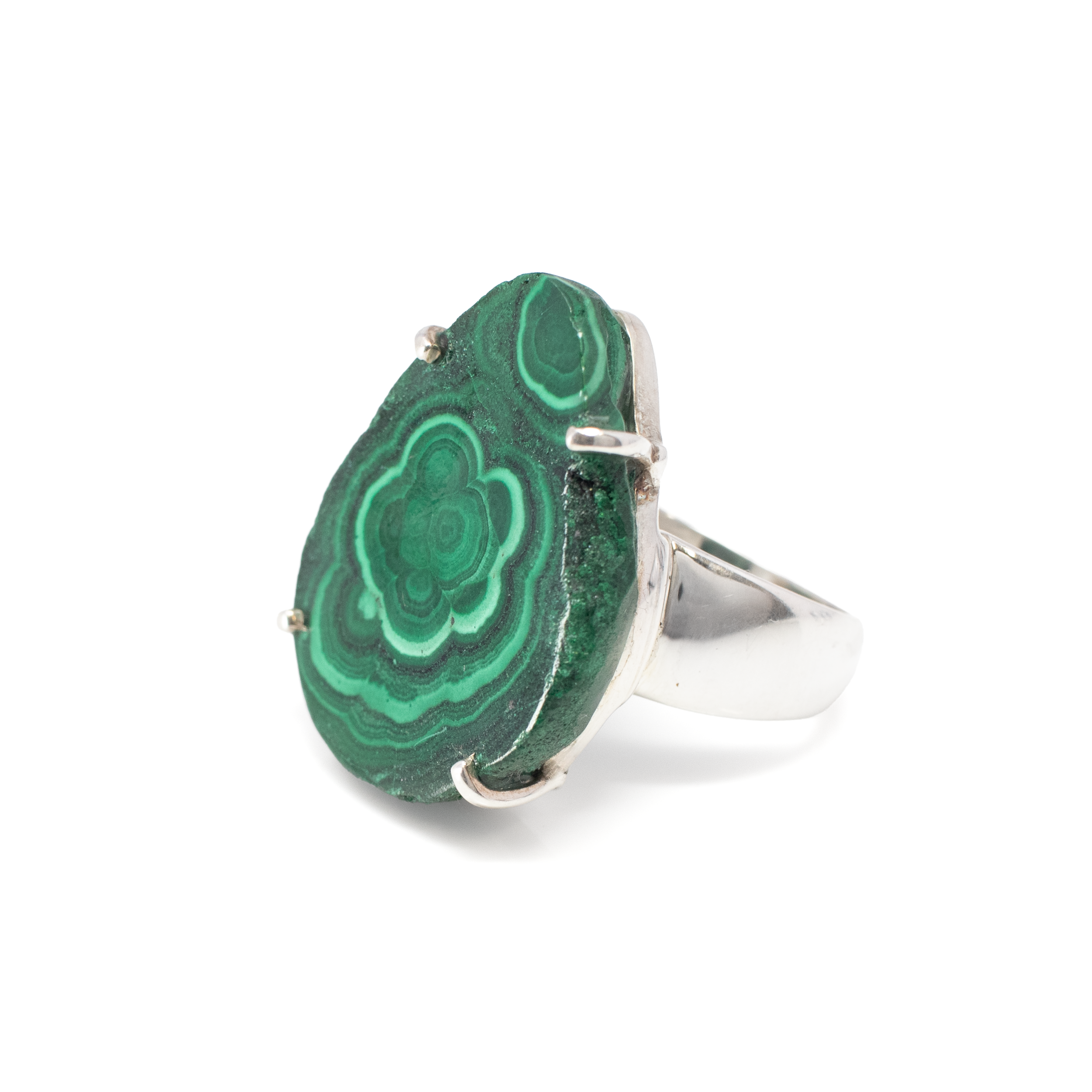 Introducing our stunning Malachite Ring featuring a mesmerizing botryoidal pear slice, elegantly prong-set on a 925 sterling silver band. This exquisite piece showcases the natural beauty of malachite, renowned for its vibrant green hues and intricate swirling patterns that evoke a sense of tranquility and groundedness.The focal point of this ring is the unique botryoidal pear slice, which displays the organic, bubbly texture characteristic of high-quality malachite. The stone's natural edge is carefully prong-set, allowing light to penetrate and highlight its captivating colors and patterns. This thoughtful design ensures that the beauty of the malachite remains the star of the show.Crafted from 925 sterling silver, the band is not only durable but also adds a touch of timeless elegance to the piece. The silver's lustrous finish perfectly complements the rich greens of the malachite, creating a harmonious blend of materials that is both eye-catching and refined. Malachite Ring - Botyroidal Pear Slice with Organic Edge Prong Set on 925 Sterling Silver Band sz10
