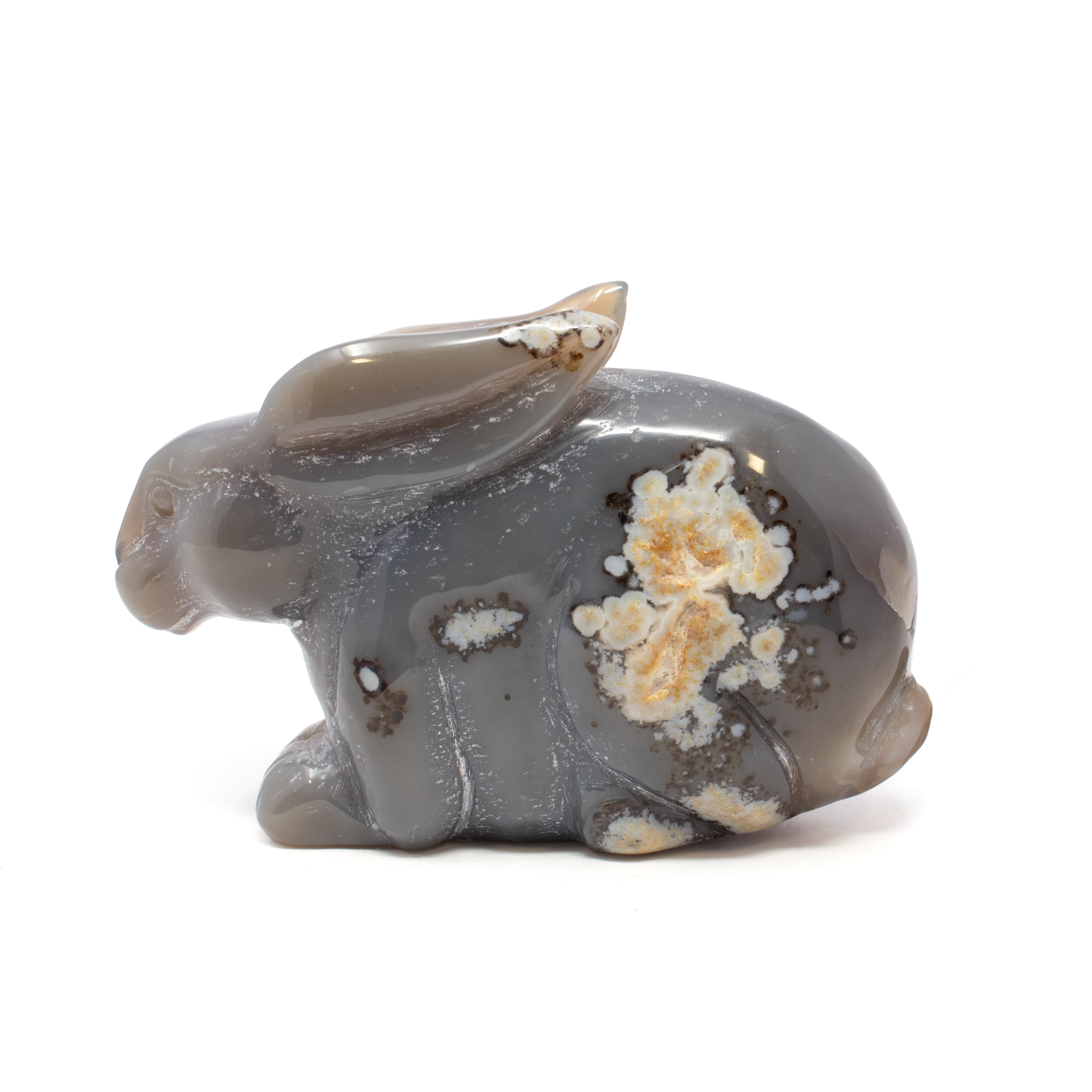 Elevate your collection with the captivating beauty of the Agate Druze Geode Rabbit Carving, a stunning fusion of nature's artistry and skilled craftsmanship. This exquisite sculpture is meticulously carved from high-quality agate, renowned for its mesmerizing patterns and rich, earthy tones. The rabbit, a symbol of abundance and good fortune, is brought to life with intricate details that highlight the natural variations and shimmering druzy crystals embedded within the geode. Each rabbit carving is a one-of-a-kind masterpiece, showcasing the distinctive bands and sparkling druze unique to every piece of agate. Revered in many cultures, the rabbit symbolizes fertility, positivity, and new beginnings, making it a meaningful gift or personal talisman. Agate Druze Geode Rabbit Carving