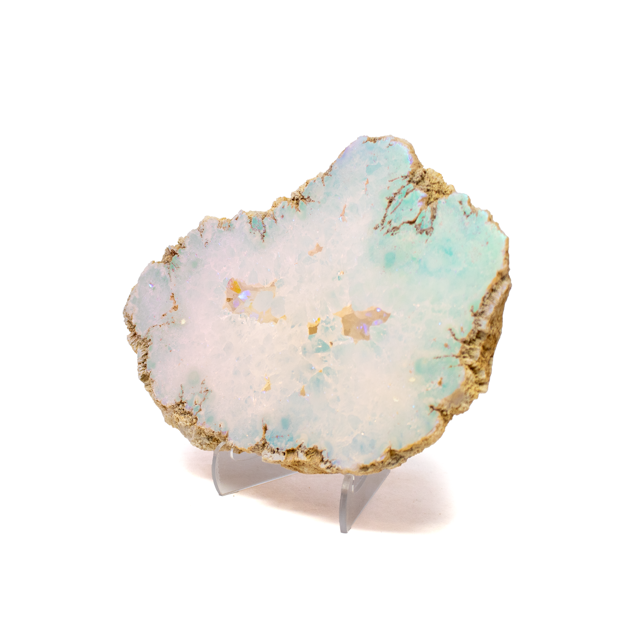 This Angel Aura Silicon Oxide Geode features a luminous cut face that shimmers with otherworldly iridescence. Platinum and silver create the radiant Angel Aura effect, casting a dreamy spectrum across its crystalline surface. Mounted on a sleek Lucite stand, the geode appears to float—a minimalist pedestal for a naturally intricate form millions of years in the making.Both a collector's gem and a statement of refined design, this piece transforms any space into a sanctuary of natural wonder and celestial light. Silicon Oxide Geode With Cut Face On Lucite Stand