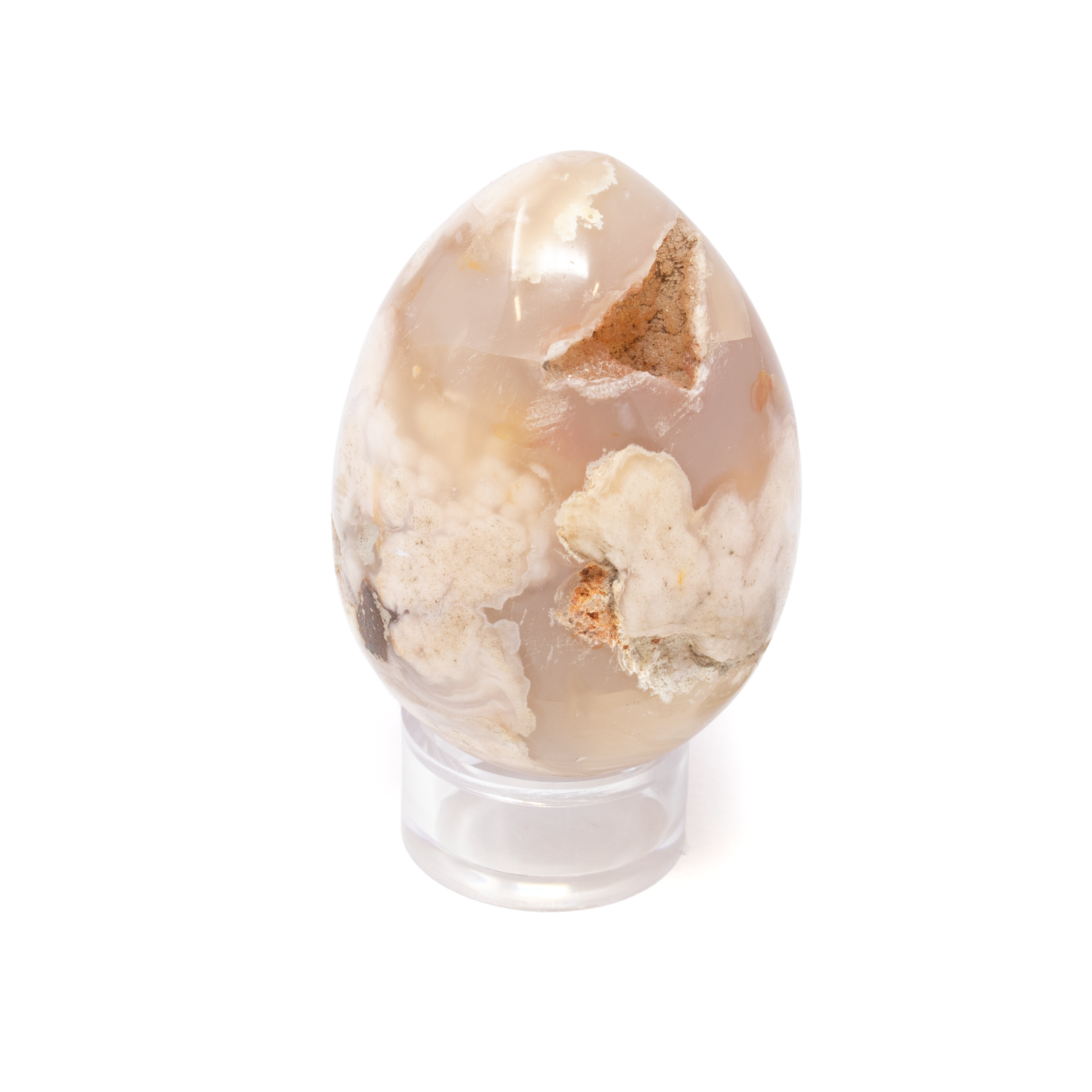 Discover the enchanting allure of our Flower Agate Egg with Druze, a mesmerizing fusion of natural beauty and spiritual harmony. This exquisite display piece combines the gentle, nurturing energy of Flower Agate with the captivating sparkle of druzy quartz, making it a must-have for crystal enthusiasts and interior decorators aliked into a smooth, elegant egg, this Flower Agate crystal showcases intricate floral patterns that are reminiscent of serene, blossoming gardens. The natural formations within the agate evoke feelings of growth, transformation, and healing, making it a perfect addition for those on a personal journey of self-discovery. A stunning druzy section embellishes the stone, offering an eye-catching shimmer that captures and reflects the light beautifully. This naturally occurring quartz druse enhances the crystal's aesthetic appeal while amplifying its metaphysical properties. Flower Agate Egg with Druze with Lucite Stand