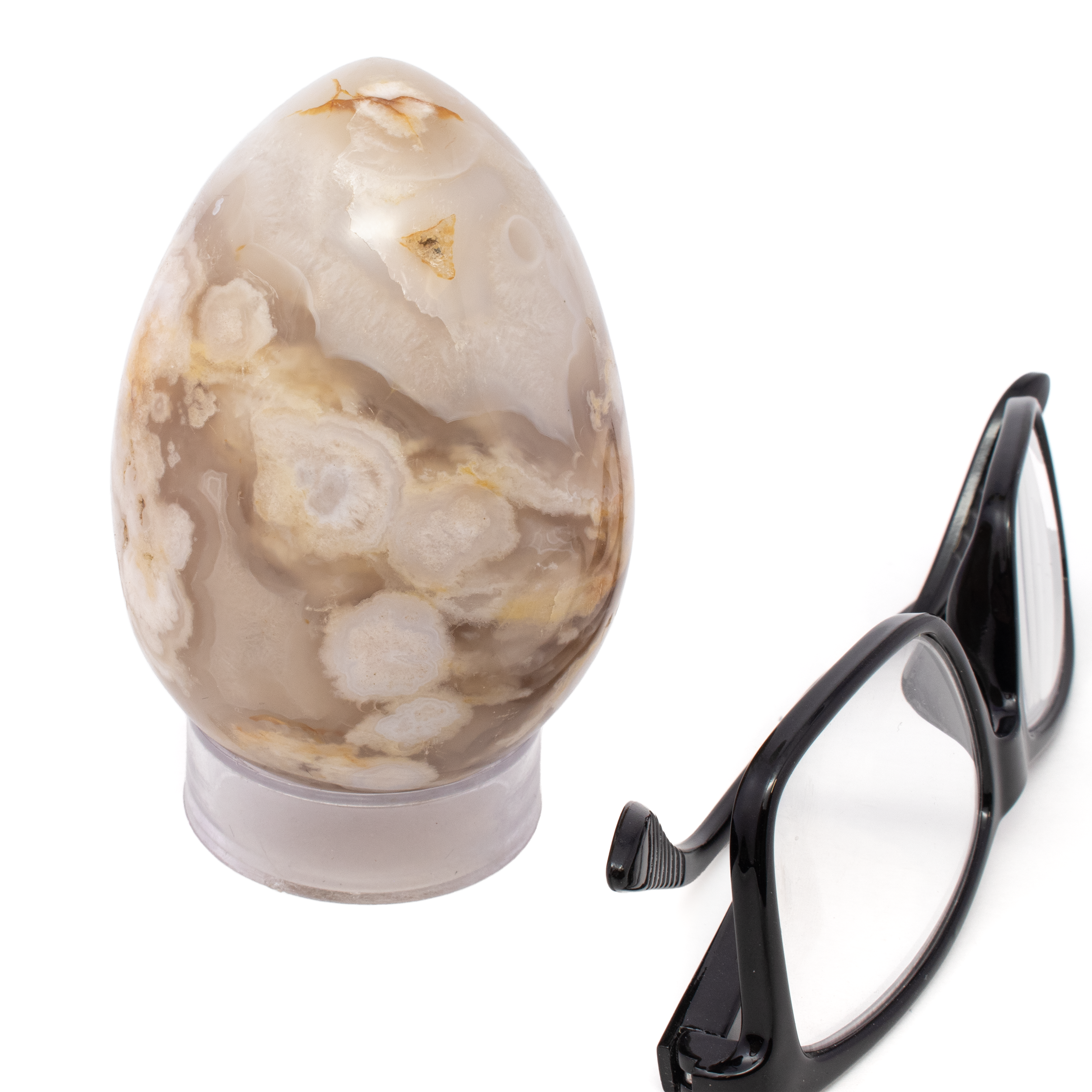 Elevate your crystal collection with the exquisite Flower Agate Egg, a captivating blend of beauty and energy. Perfectly polished into a smooth, egg-like shape, this stunning piece showcases the unique floral patterns intrinsic to Flower Agate—a crystal revered for its nurturing and growth-enhancing properties.Each Flower Agate Egg boasts its own distinct patterns reminiscent of blooming flowers, making it a one-of-a-kind treasure. Known to foster personal growth, Flower Agate encourages new beginnings and emotional balance, making it a wonderful addition for spiritual and meditative practices. The harmonious egg shape symbolizes fertility, rebirth, and the infinite cycles of life, adding a layer of symbolic meaning to your space. Flower Agate Egg with Lucite Stand