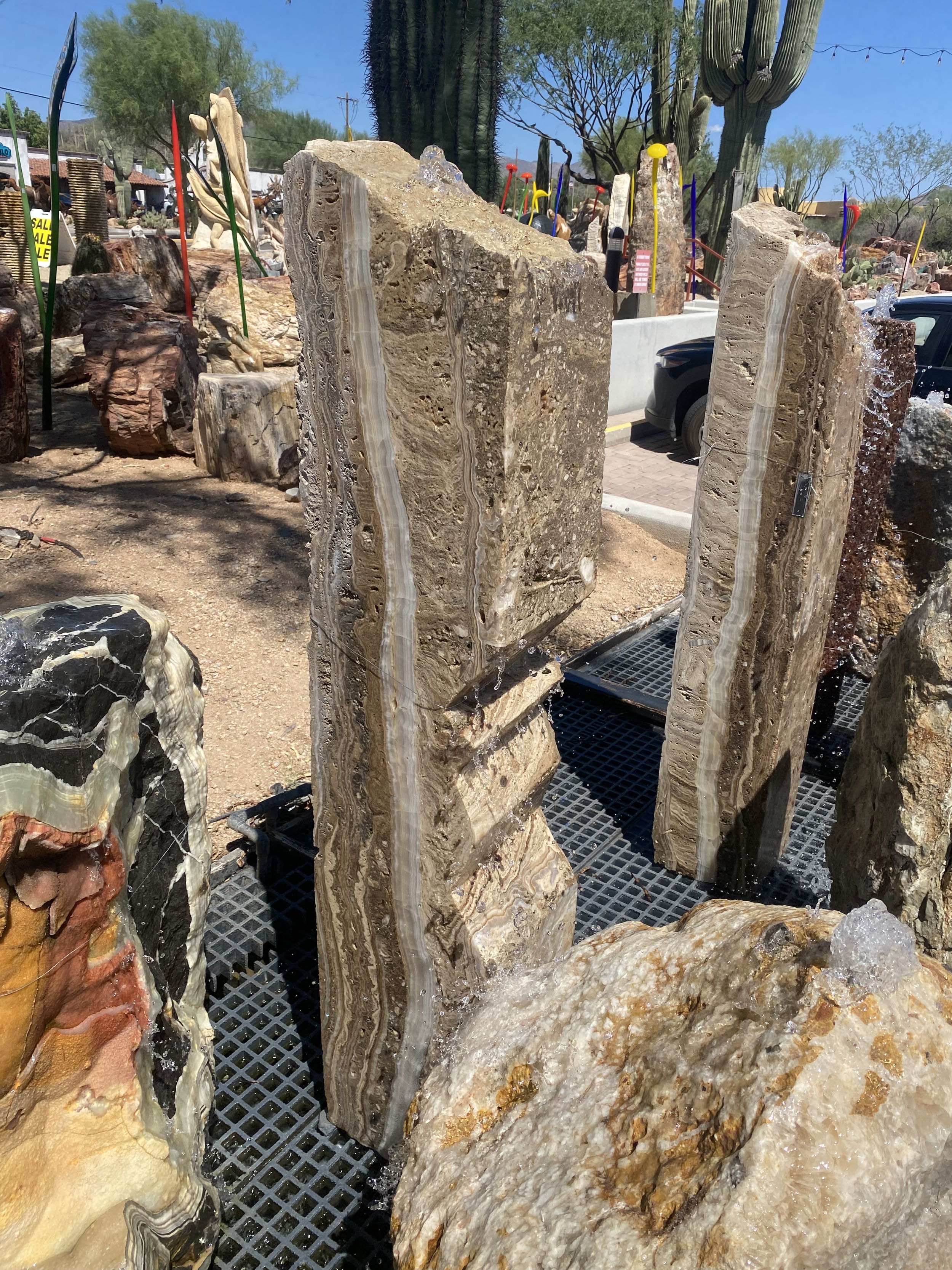 The Travertine & Onyx Angle Cut Column Fountain creates a tranquil atmosphere in your yard or garden with a visually appealing design. Its unique column shape and materials provide an aesthetically pleasing addition to any patio or outdoor space. Let Rare Earth Gallery’s white-glove service make your fountain dreams come true—simply choose your fountain, tell us where it goes, and we’ll handle the rest, from delivery to installation. IMPORTANT: the purchase price listed is for the FOUNTAIN ONLY and DOES NOT INCLUDE the cost of a basin, pump, parts or installation. Before purchasing a fountain online, we STRONGLY recommend you call us at (480) 575-4360 for a FREE consultation to discuss these additional costs and schedule a pre-site inspection. Also, free shipping does NOT apply to fountains, please call for a quote. Travertine & Onyx Angle Cut Column Fountain